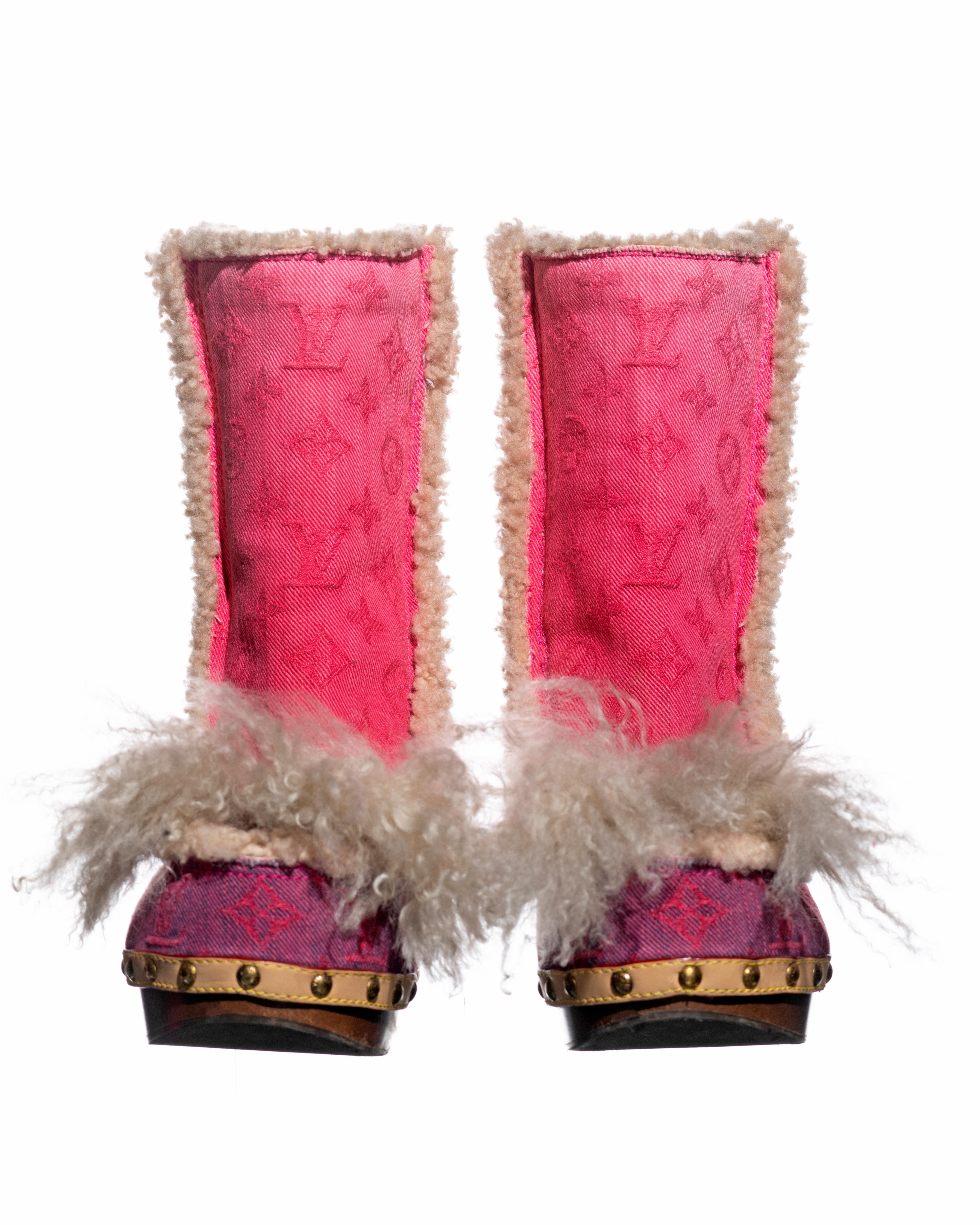 ▪ Rare Louis Vuitton denim clog boots 
▪ Designed by Marc Jacobs 
▪ Ombre pink monogram jacquard denim 
▪ Cream shearling interior and trim 
▪ Wooden clog-style sole with leather trim and gold studs
▪ Mongolian lamb tassels at the toe
▪ Pink metal