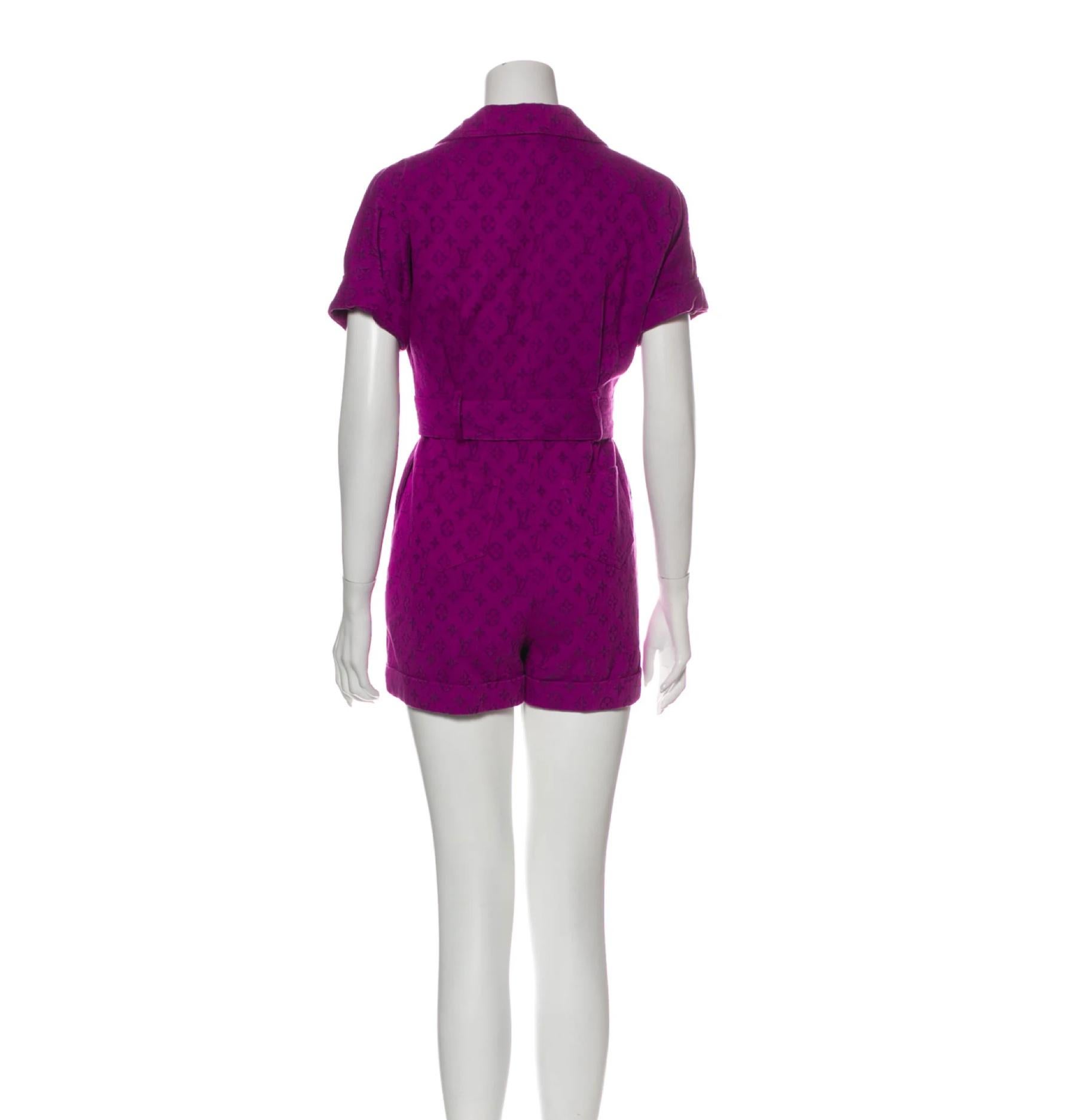 Louis Vuitton V Neck Romper. Featuring short sleeves with a v-neck design and button closures at the front. 

COLOR: Purple
MATERIAL: 100% cotton
SIZE: Small 
CONDITION: Excellent, no visible signs of wear. 

MEASURES
Bust: 28