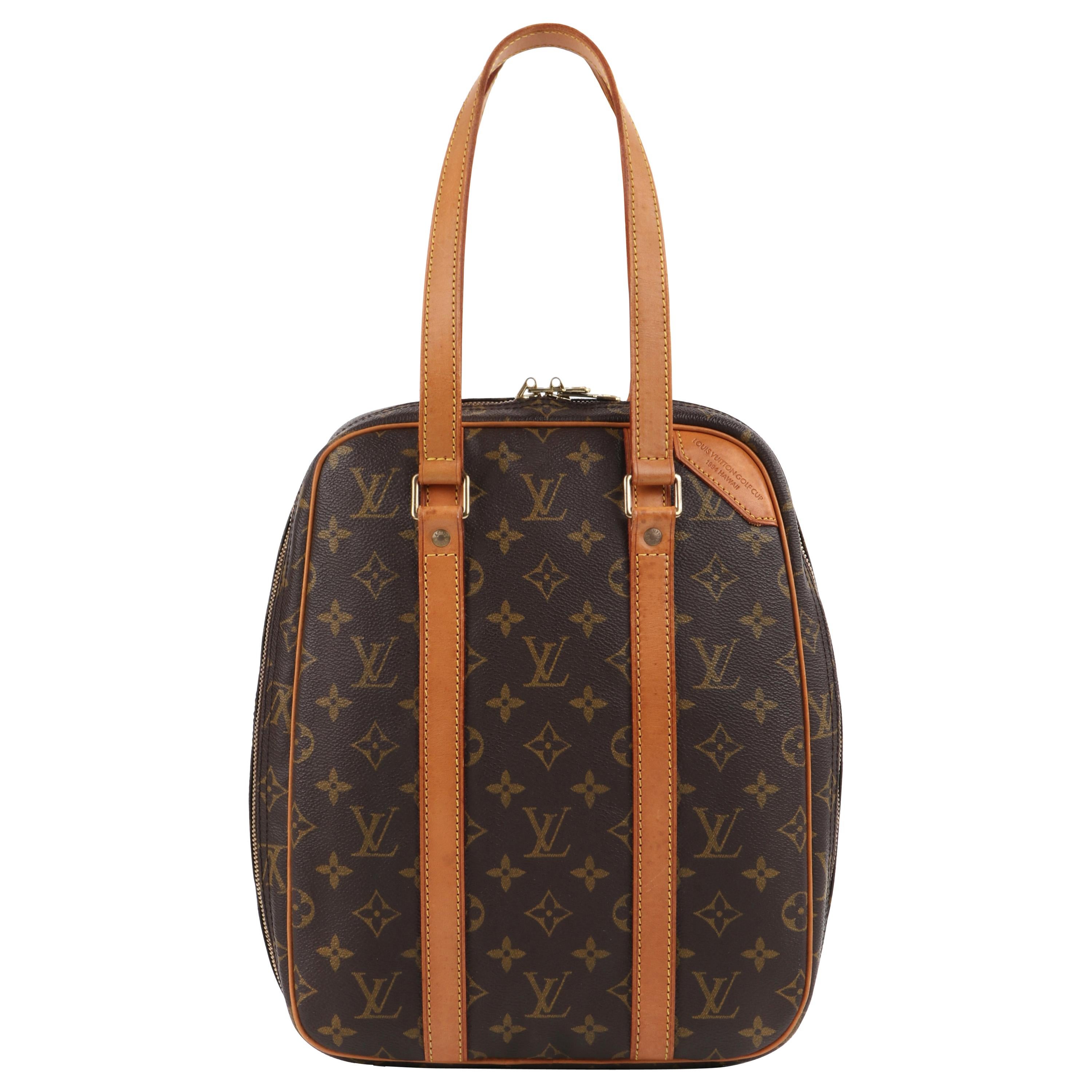 A LOUIS VUITTON MONOGRAMMED HANDBAG, the two front pockets with LV  hardware, buckle fastener, adjust
