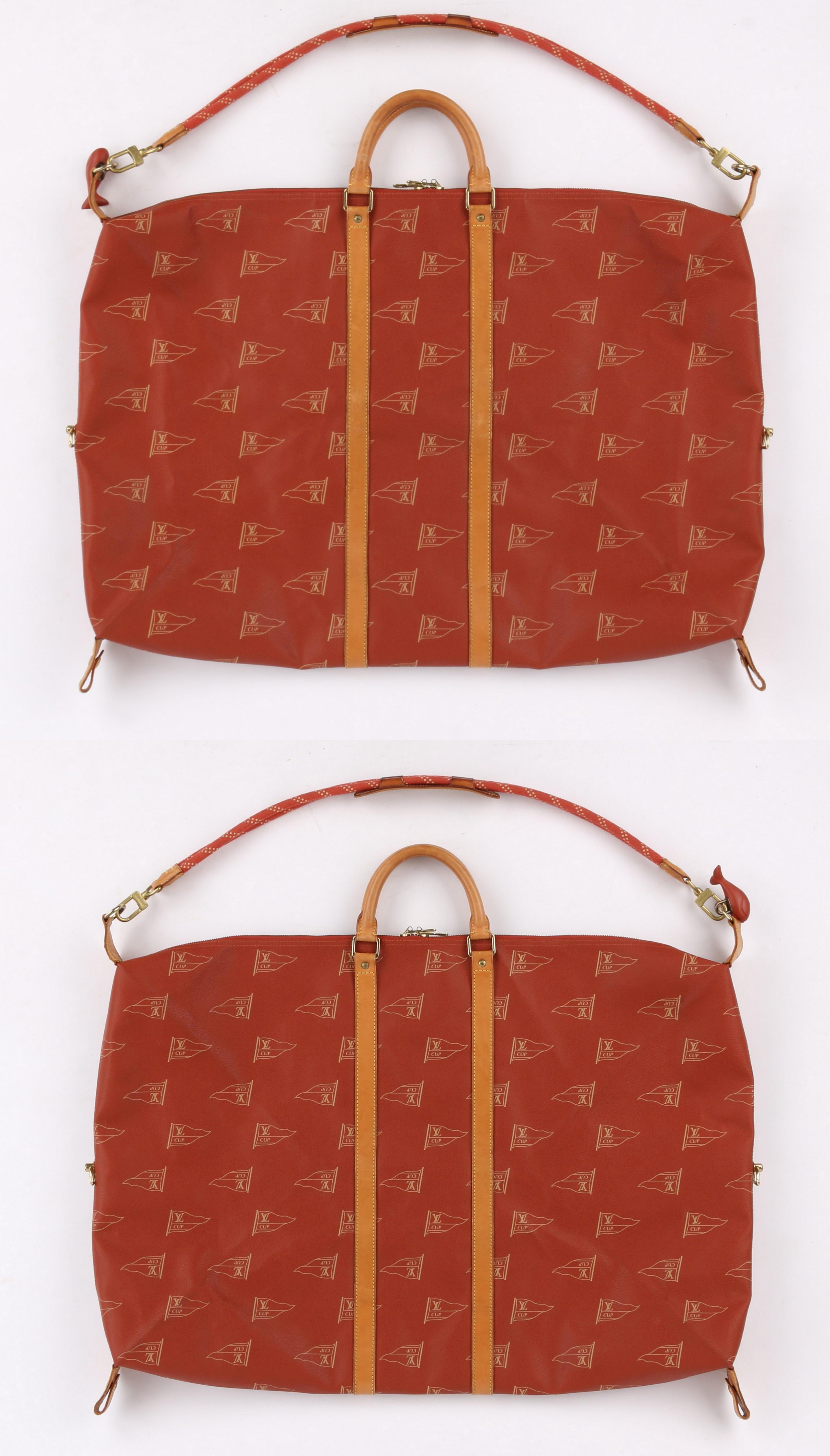 DESCRIPTION: LOUIS VUITTON c.1995 LV America's Cup Garment Duffel Bag w/ Whale Lock Ltd Ed
 
Circa: c.1995 
Label(s): Louis Vuitton 
Designer: 
Style: Garment / Duffel bag
Color(s): Shades of red, beige, and tan leather
Lined: No
Marked Fabric