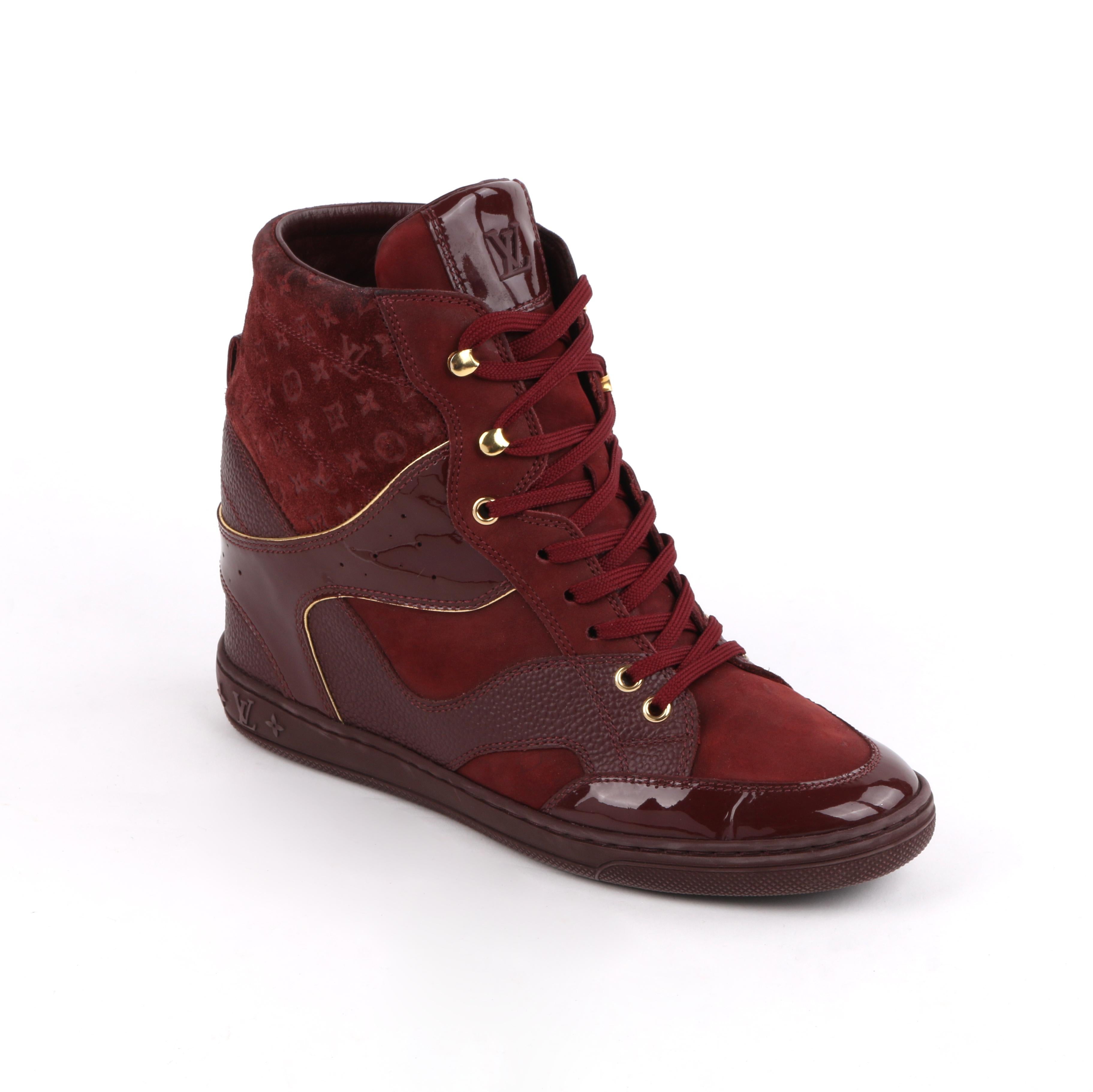 LOUIS VUITTON c.2014 Burgundy Bordeaux Monogram Suede Cliff Top Wedge Sneakers
 
Estimated Retail Price: $855.00
 
Brand / Manufacturer: Louis Vuitton 
Style: Wedge Sneakers
Color(s): Burgundy and gold 
Unmarked Materials: Rubber (sole); leather