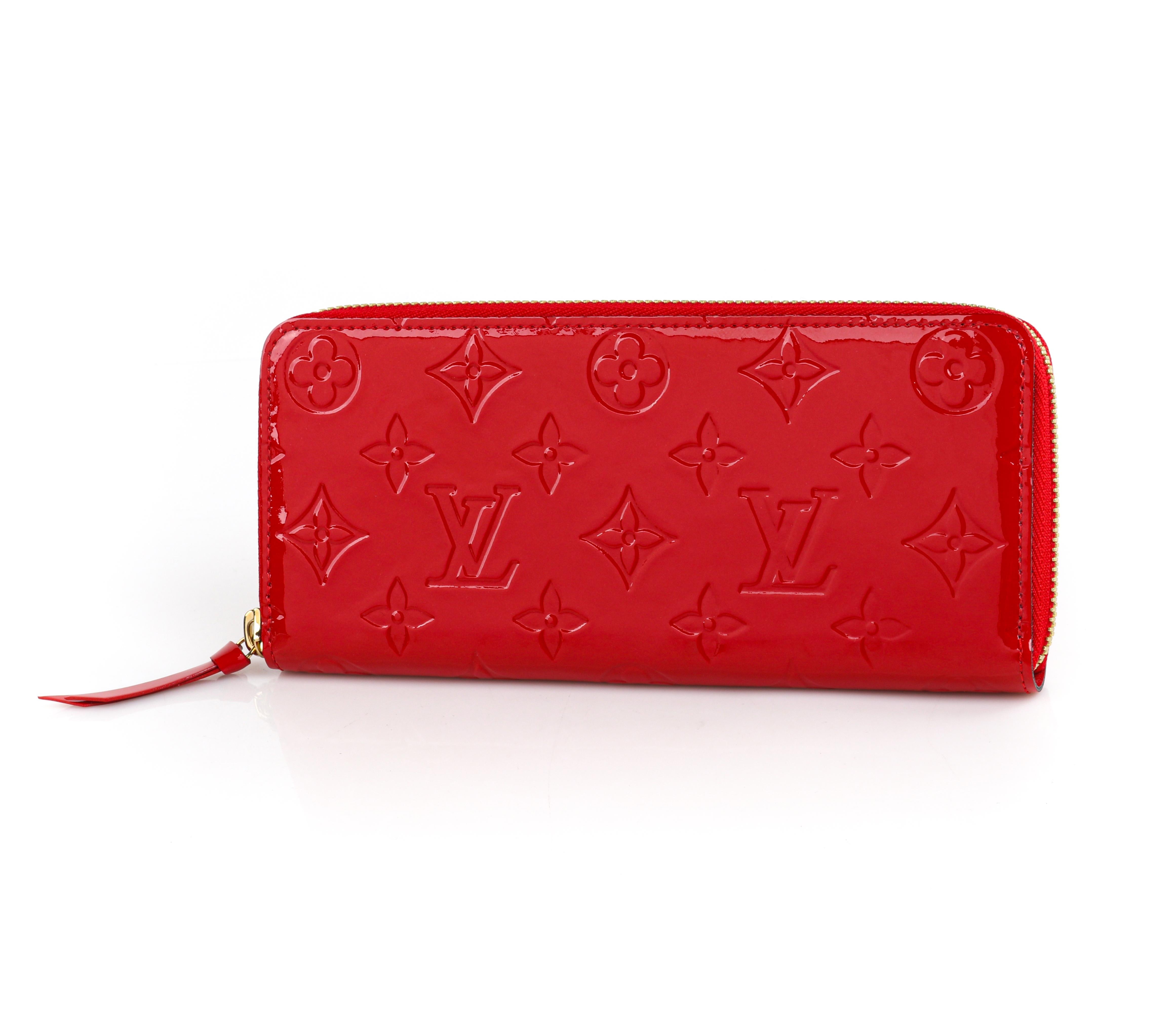 LOUIS VUITTON c.2015 “Clemence” Red Monogram Vernis Leather Zip Around Wallet
 
Estimated Retail: $970.00
 
Brand/Manufacturer:  Louis Vuitton 
Circa: 2015
Designer: Nicolas Ghesquiere
Style: Zip-up wallet
Color(s): “Cherry” red
Lined: Yes
Unmarked