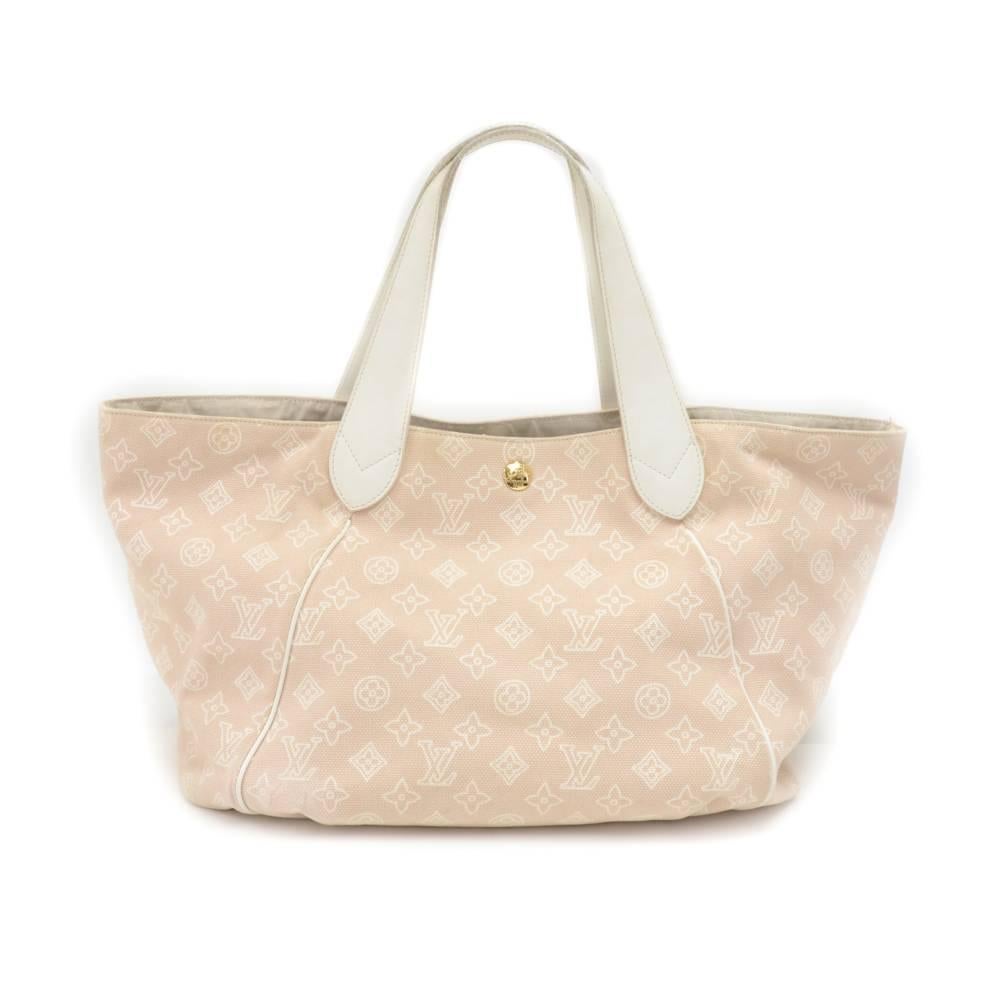 This is Louis Vuitton Cabas Ipanema GM 2009 limited edition hand bag. The bag is secured with hook and the one zipper pocket on front. Inside is in canvas lining with 1 open pocket, 1 for mobile and 1 attached pouch with zipper. A gold tone metal