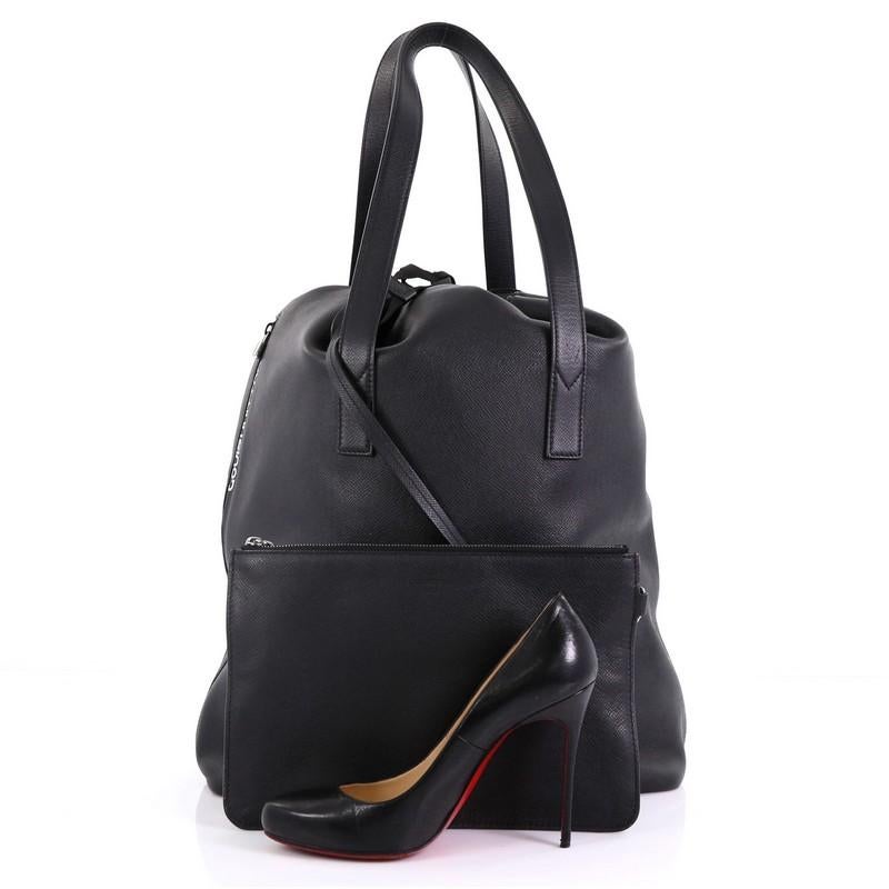 This Louis Vuitton Cabas Light Drawstring Bag Taiga Leather, crafted in black taiga leather, features dual flat leather handles and gunmetal-tone hardware. Its drawstring closure opens to a black fabric interior. Authenticity code reads: FO0148.