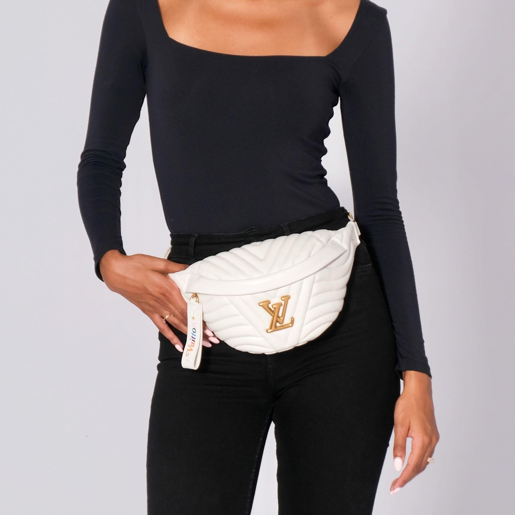 This waist bag is crafted of calfskin leather in white. The bag features a white leather adjustable waist strap and a front gold hardware LV logo. The zipper opens to a white fabric interior. Retail.

Color: white
Material: