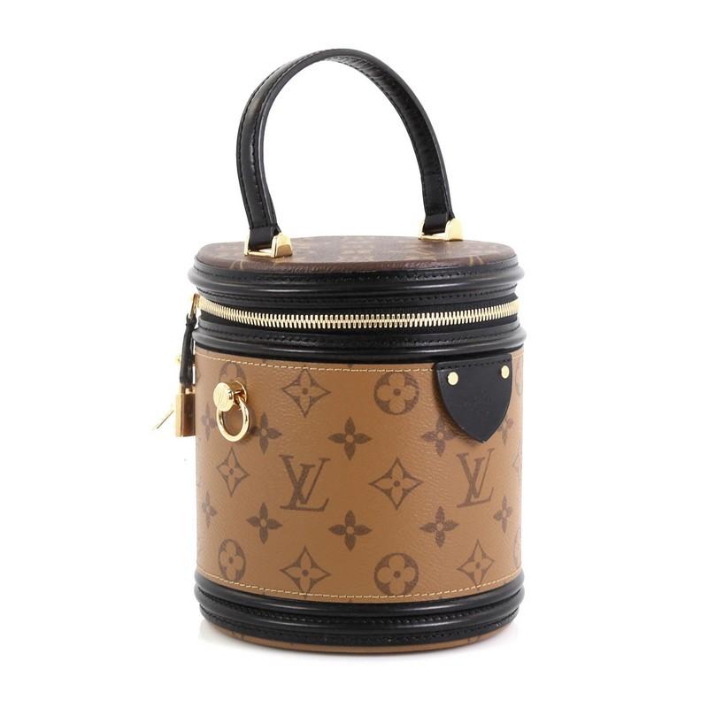 This Louis Vuitton Cannes Handbag Reverse Monogram Canvas, crafted from brown reverse monogram coated canvas, features leather top handle, leather trim and gold-tone hardware. Its zip-around closure opens to a black microfiber interior. Authenticity