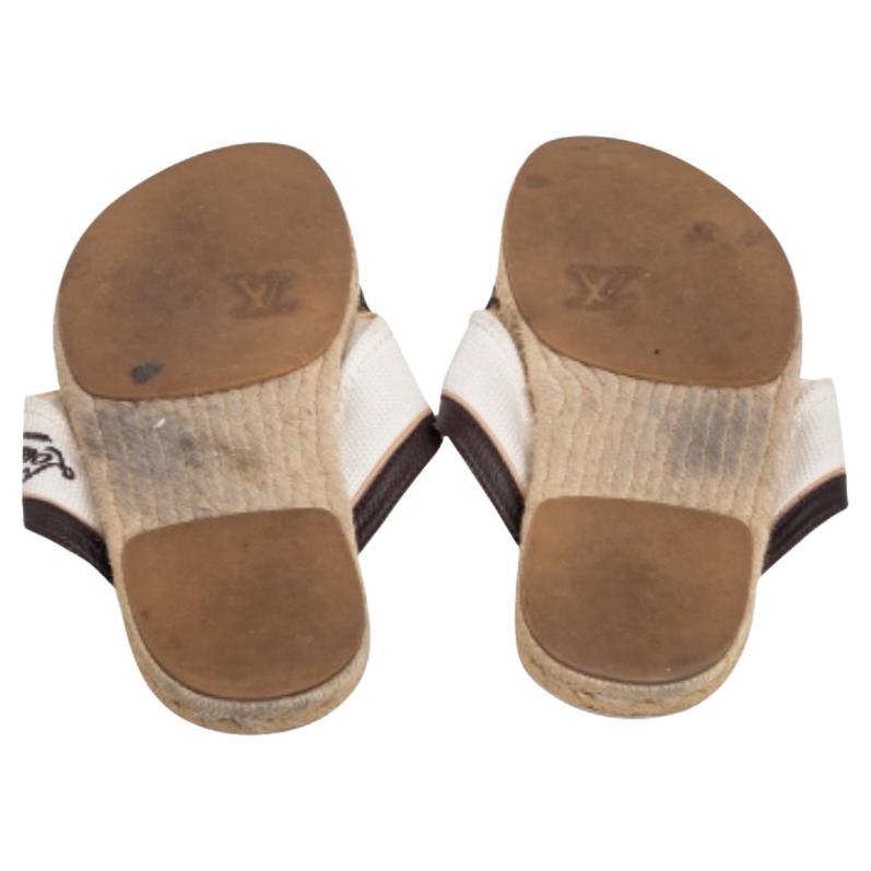 This pair of sandals by Louis Vuitton will surely assist you with comfort and style. Crafted with canvas and leather, they feature impressive criss-cross strap detailing accompanied by LV details. This pair is finished with leather-lined insoles.