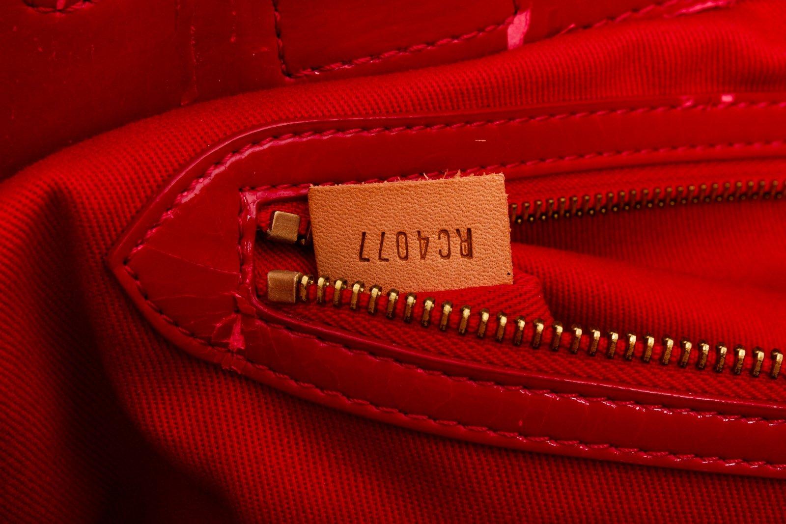 Brown and tan monogram coated canvas Louis Vuitton Rubis Salina with gold-tone hardware, tan vachetta leather and red embossed patent leather trim, dual flat shoulder straps, red canvas lining, three interior pockets; one with zip closure and clasp