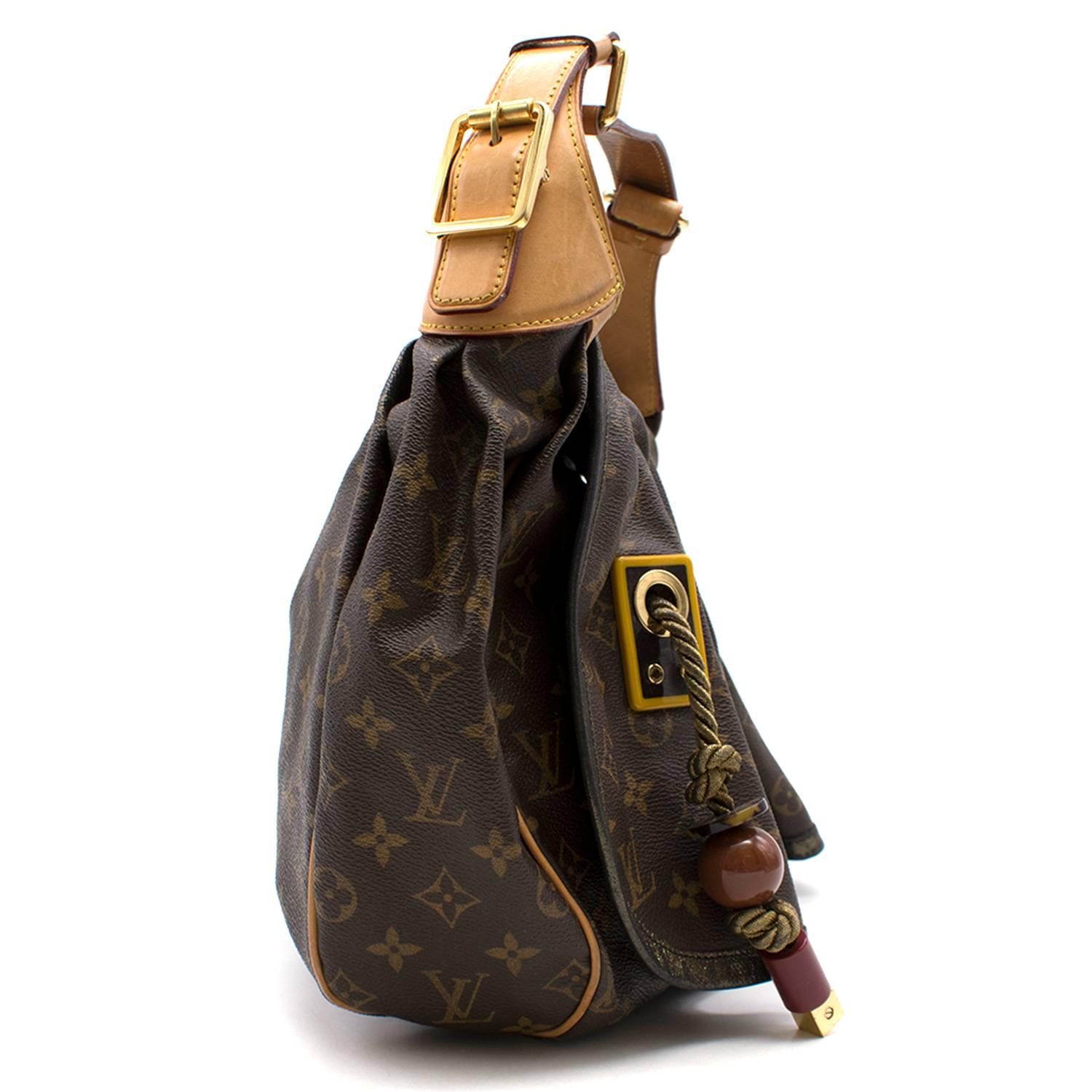 Louis Vuitton canvas bag

- Leather strap
- Rope tassel detailing with large bead details situated at the front of the bag
- Gold coloured metal hardware on the tassels and on the strap.
- Interior lined with suede and two interior slip