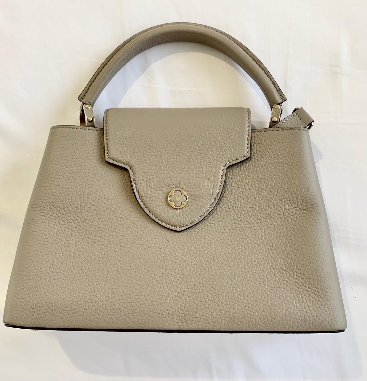 Louis Vuitton Capucines BB bag in galet/ pebble in Excellent condition - Only used once
No marks whatsoever on the bag
Only a few dust marks on the inside of the box and the dust bag.

Fashioned from full-grain Taurillon leather, the now-classic