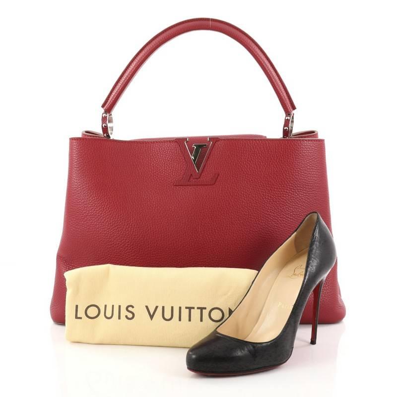 This authentic Louis Vuitton Capucines Handbag Leather GM is sophisticated and fresh in design. Crafted from red taurillon leather, this ultra-chic bag features a single rolled leather handle secured by jewel-like rings, top flap with the classic