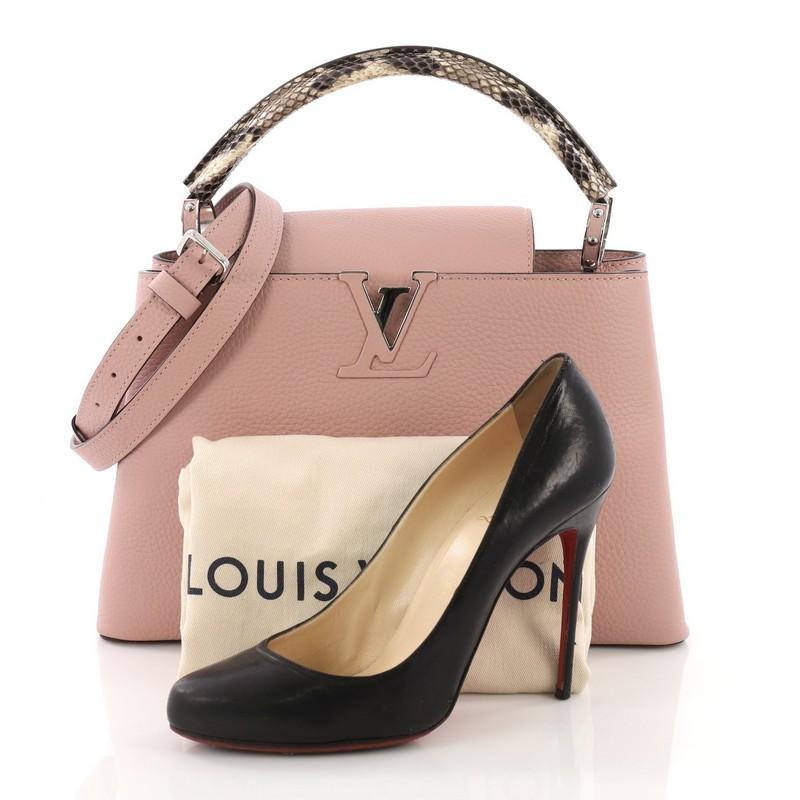 This Louis Vuitton Capucines Handbag Leather with Python PM, crafted in pink leather, features a single rolled genuine python handle secured by jewel-like rings, frontal flap with the classic monogram flower, and silver-tone hardware. Its flap that