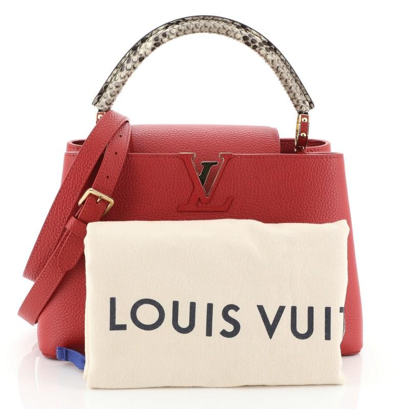 This Louis Vuitton Capucines Handbag Leather with Python PM, crafted from red leather and genuine python, features a single loop handle with jewel-like rings, frontal flap with monogram flower hardware, and gold-tone hardware. Its center hook