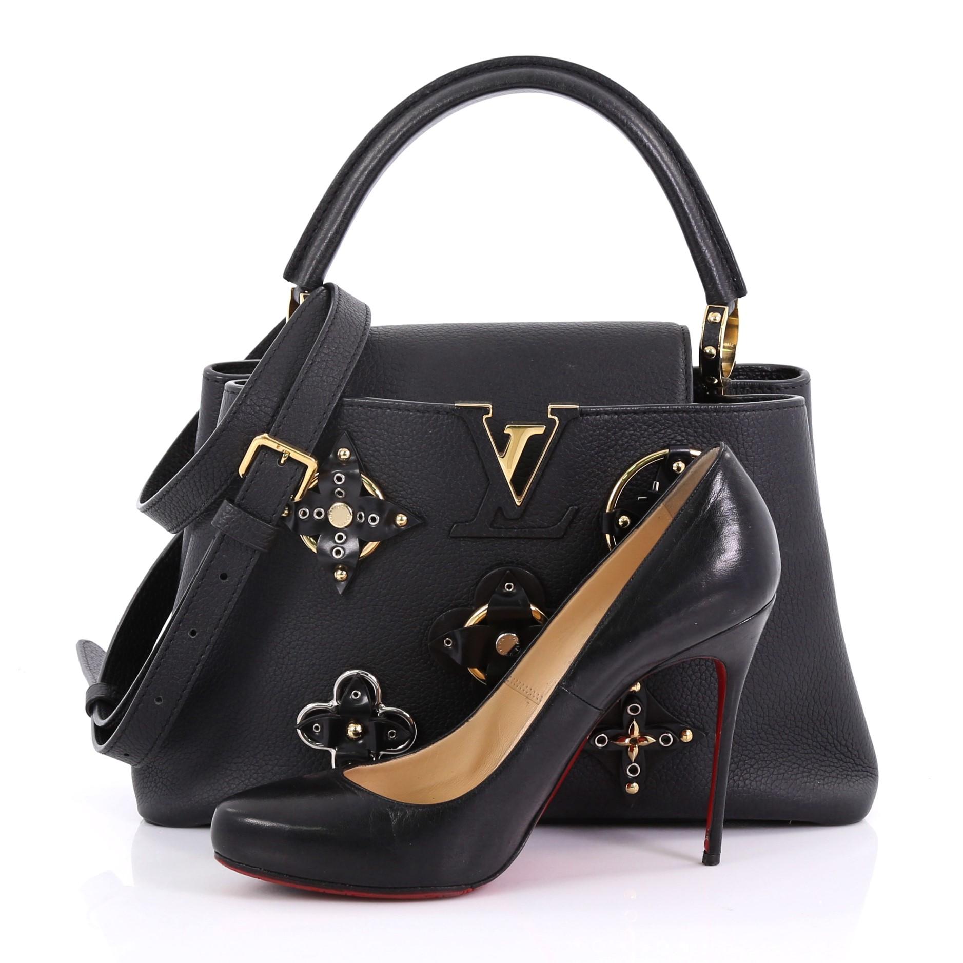 This Louis Vuitton Capucines Handbag Limited Edition Mechanical Flowers Leather PM, crafted in black mechanical flowers leather, features a single loop leather handle, frontal flap, and gold-tone hardware. Its flap can be tucked inside to reveal the