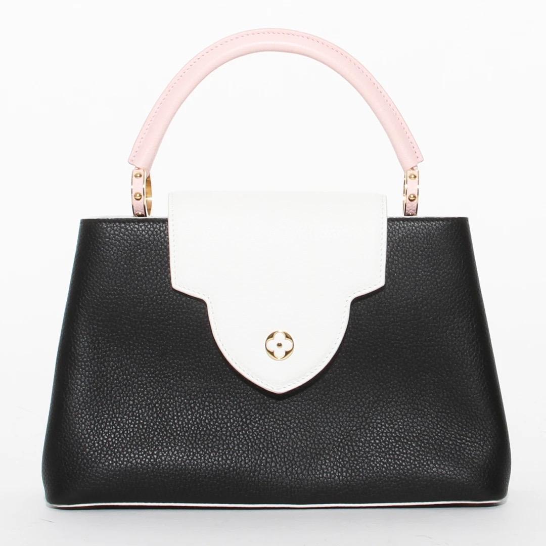 Capucines pm neapolitan by Louis Vuitton 
2019 Collection
Black/white/pink leather 
Gold tone hardware
Single top handle
Logo adornment at front face
Protective feet at base
Dual interior compartments
Single zip pocket at interior wall and fold-in