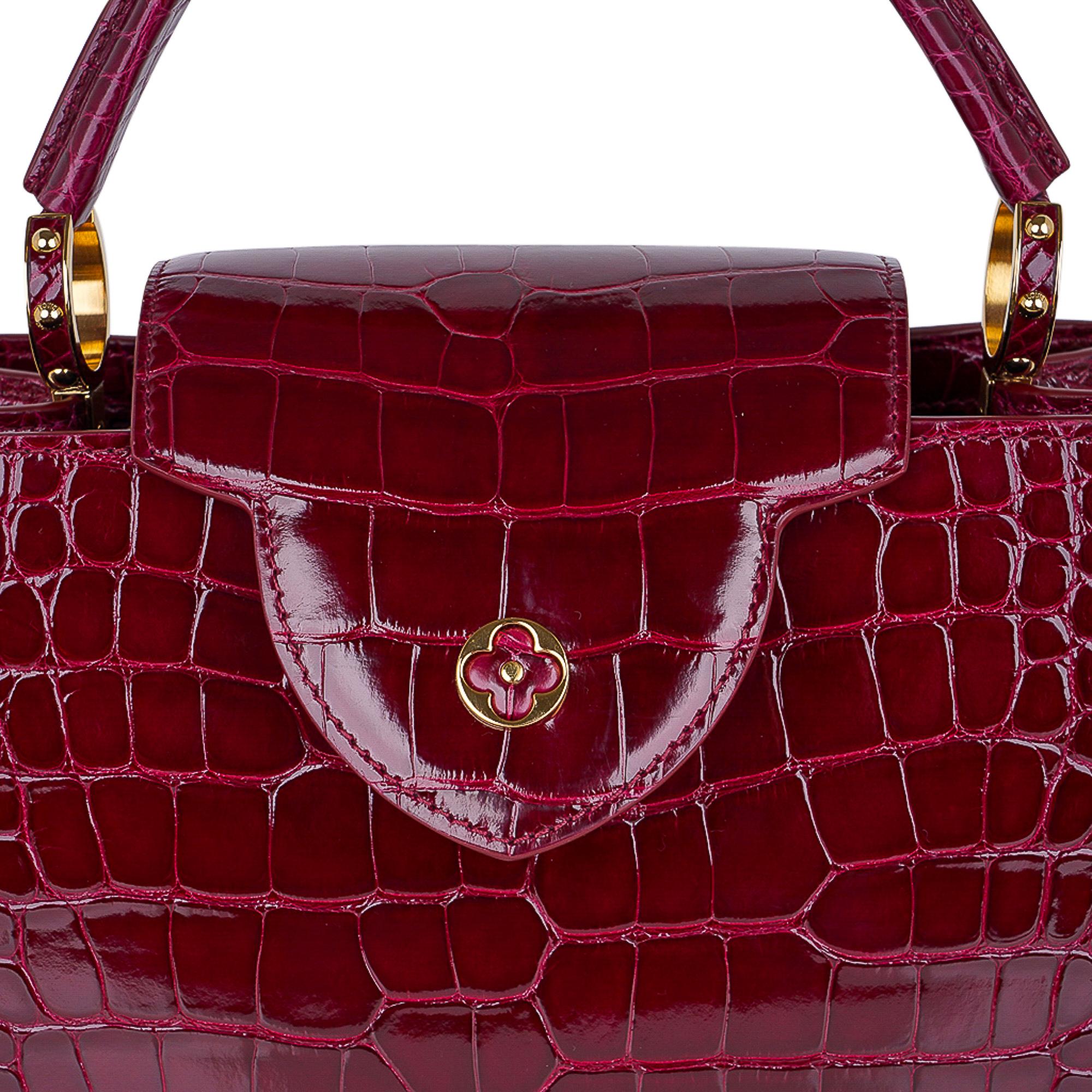 Guaranteed authentic limited edition special order Louis Vuitton Capucines PM crocodile bag featured in rich jeweled toned Wildcat..
Exquisite and effortlessly sleek, this Louis Vuitton bag is considered a classic.
Handles secured by jewel-like