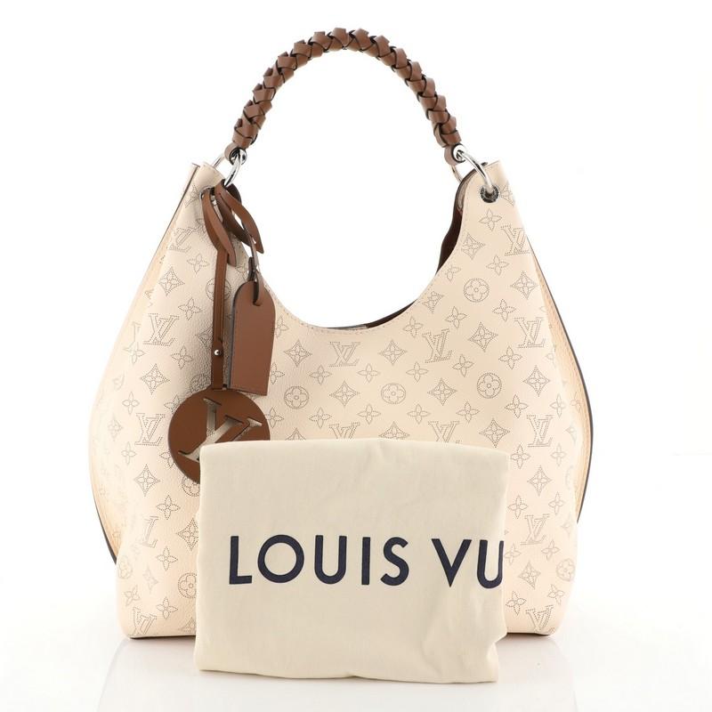 This Louis Vuitton Carmel Hobo Mahina Leather, crafted in neutral leather, features a braided handle and silver-tone hardware. It opens to a brown microfiber interior with zip pocket. Authenticity code reads: AH3129.

Estimated Retail Price: