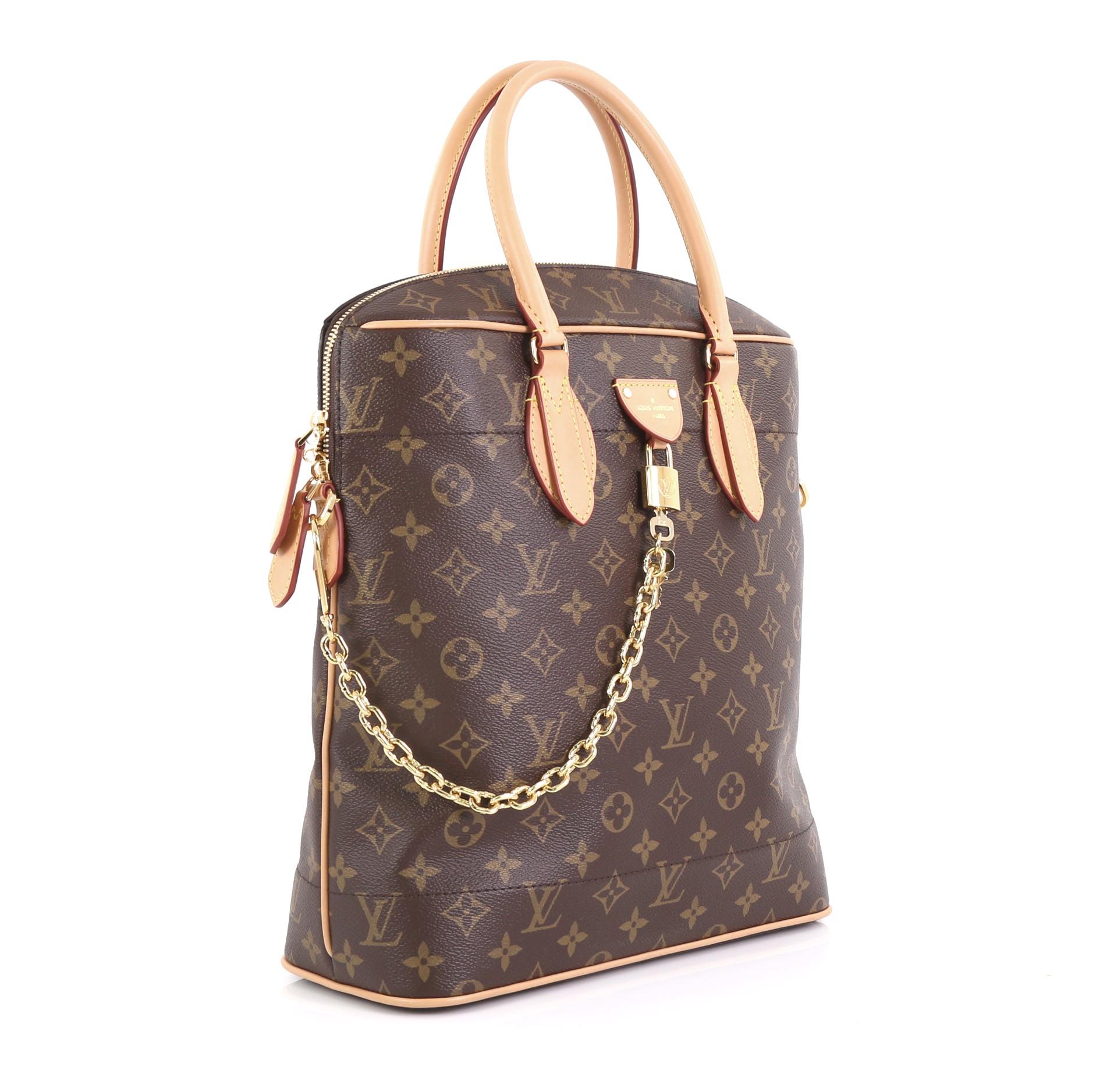 This Louis Vuitton Carry All Handbag Monogram Canvas MM, crafted in brown monogram coated canvas, features dual rolled leather handles, cowhide leather trim, chain links, and gold-tone hardware. Its zip closure opens to a brown microfiber interior