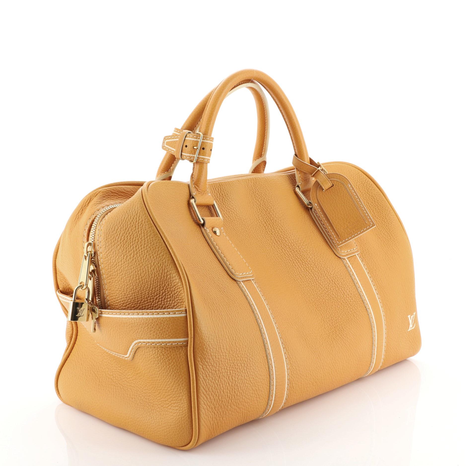 This Louis Vuitton Carryall Handbag Tobago Leather, crafted in orange tobago leather, features dual rolled handles and gold-tone hardware. Its zip closure opens to a brown fabric interior. Authenticity code reads: TH0016. 

Estimated Retail Price: