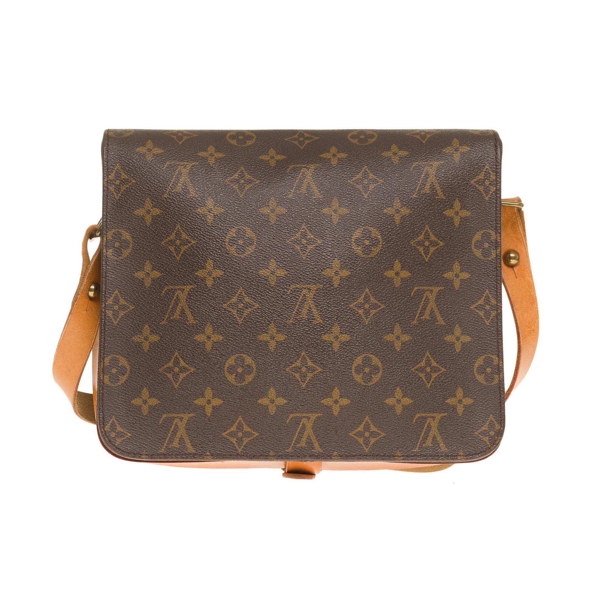 The Gorgeous Louis Vuitton Cartouchière GM shoulder bag in brown monogram canvas and natural leather, gilded metal hardware, an adjustable shoulder strap in natural leather for a shoulder or crossbody wear

Buckle closure on flap
Brown leather