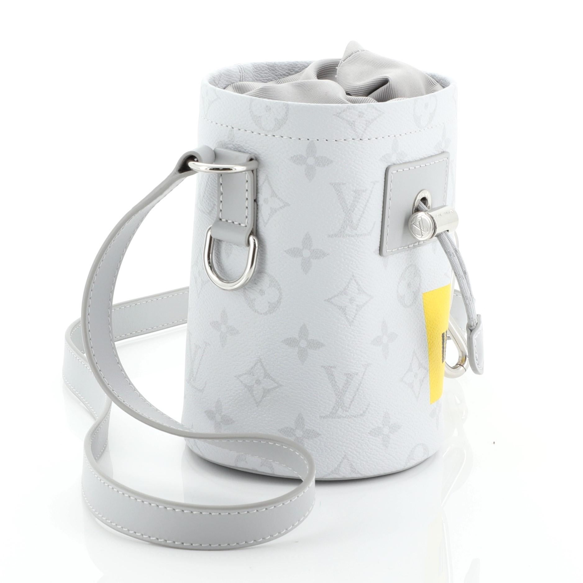 This Louis Vuitton Chalk Nano Bag Limited Edition Monogram White Canvas, crafted in gray coated canvas, features a leather shoulder strap, a shape inspired by climbers' chalk bags, chain and functional carabiner fastening on the strap and
