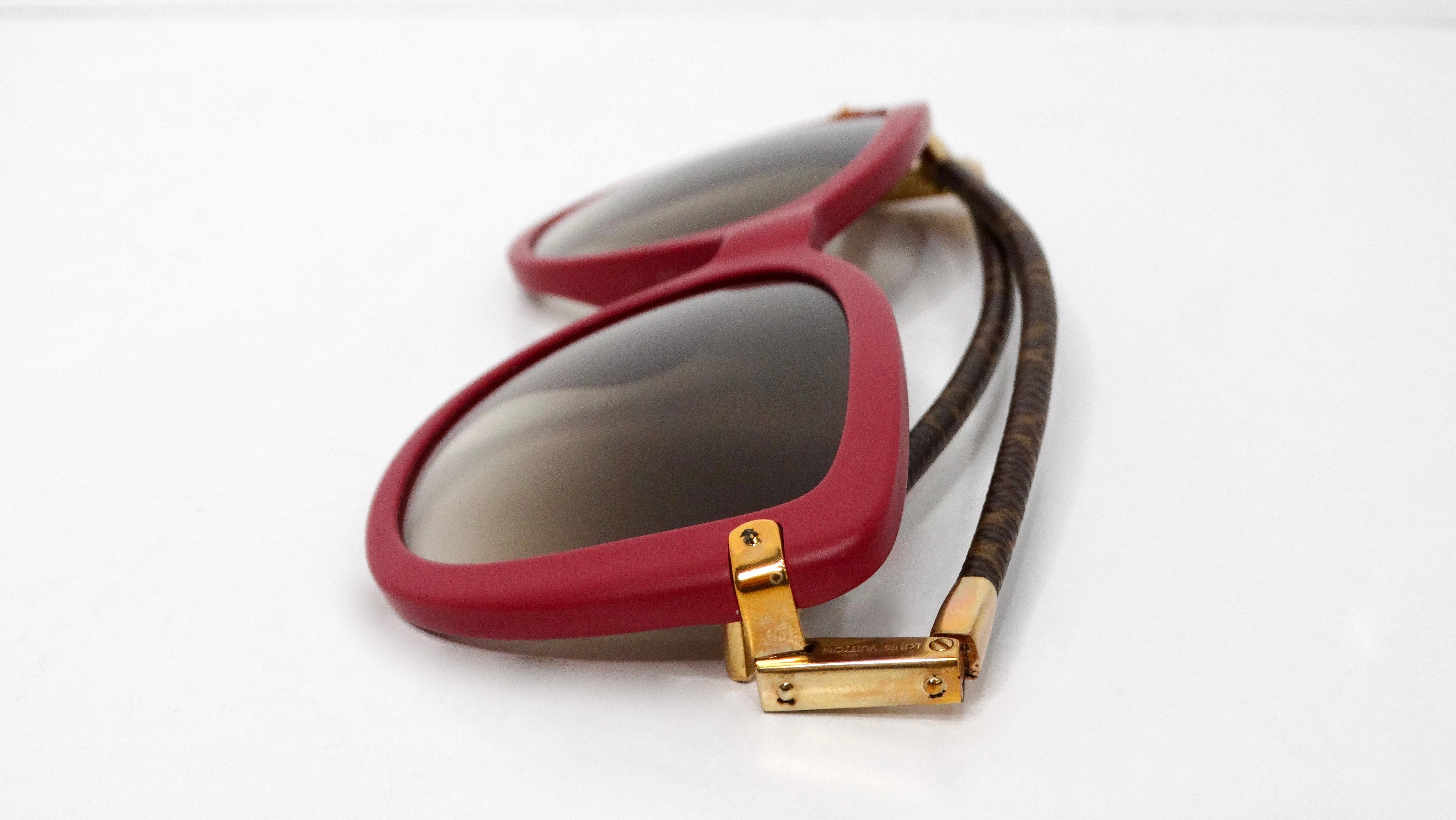 The Louis Vuitton Charlotte Frame Purple Acetate Monogram Foldable Sunglasses are a statement accessory that effortlessly blends bold design with luxury. Featuring a vibrant raspberry purple frame, these sunglasses stand out while exuding elegance.