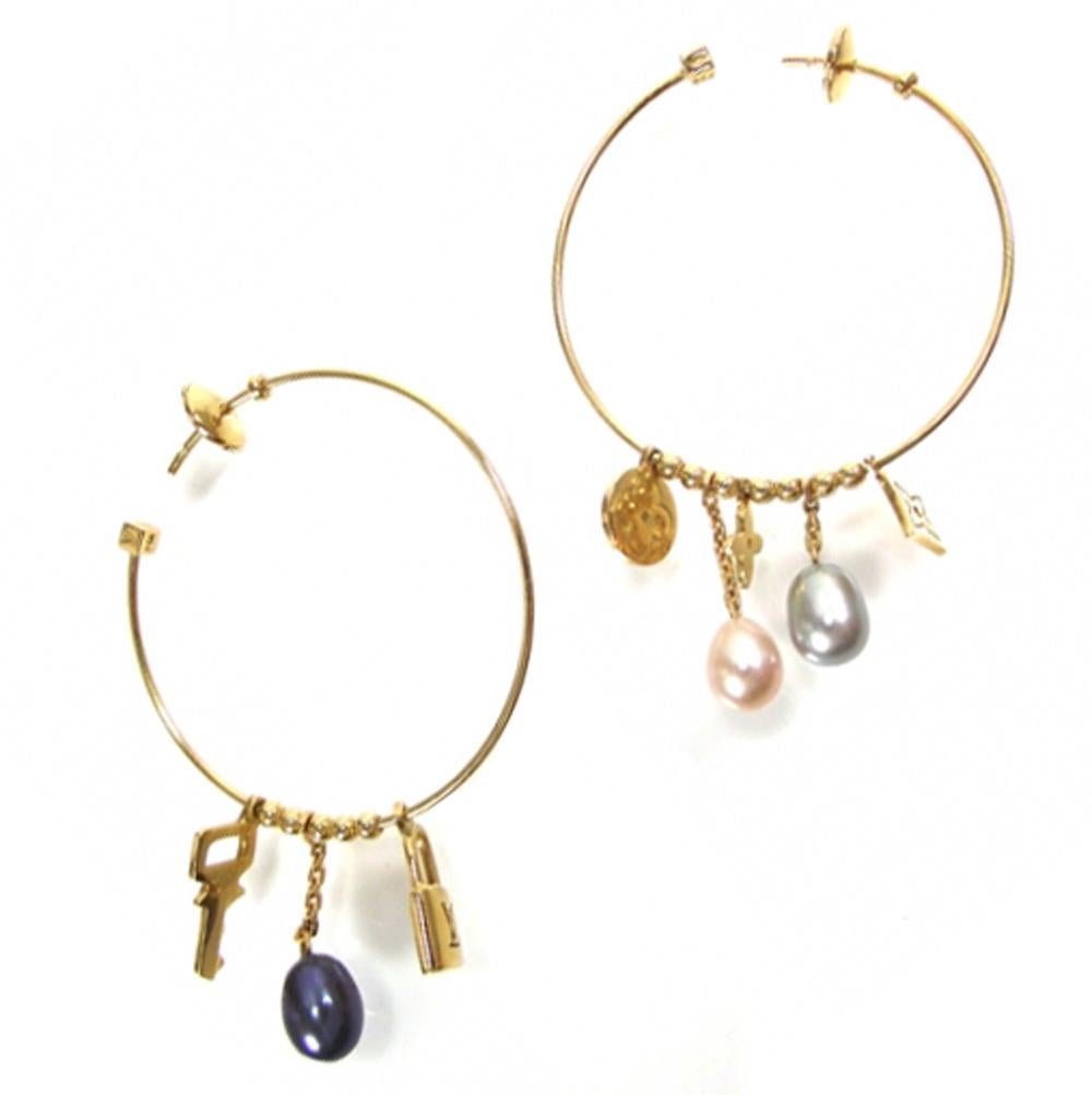 An authentic pair of 18k yellow gold hoop earrings, crafted by Louis Vuitton, decorated with pearls and monogram charms. Earrings are 40mm in diameter. Marked: 750, French marks, LV. 

