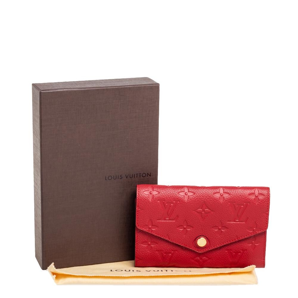 Carry your monetary essentials safely in this chic Curieuse wallet from Louis Vuitton. It is made from Cherry Monogram Empreinte leather, with a gold-toned accent decorating the flap. Lined with leather, the interior of this wallet is designed