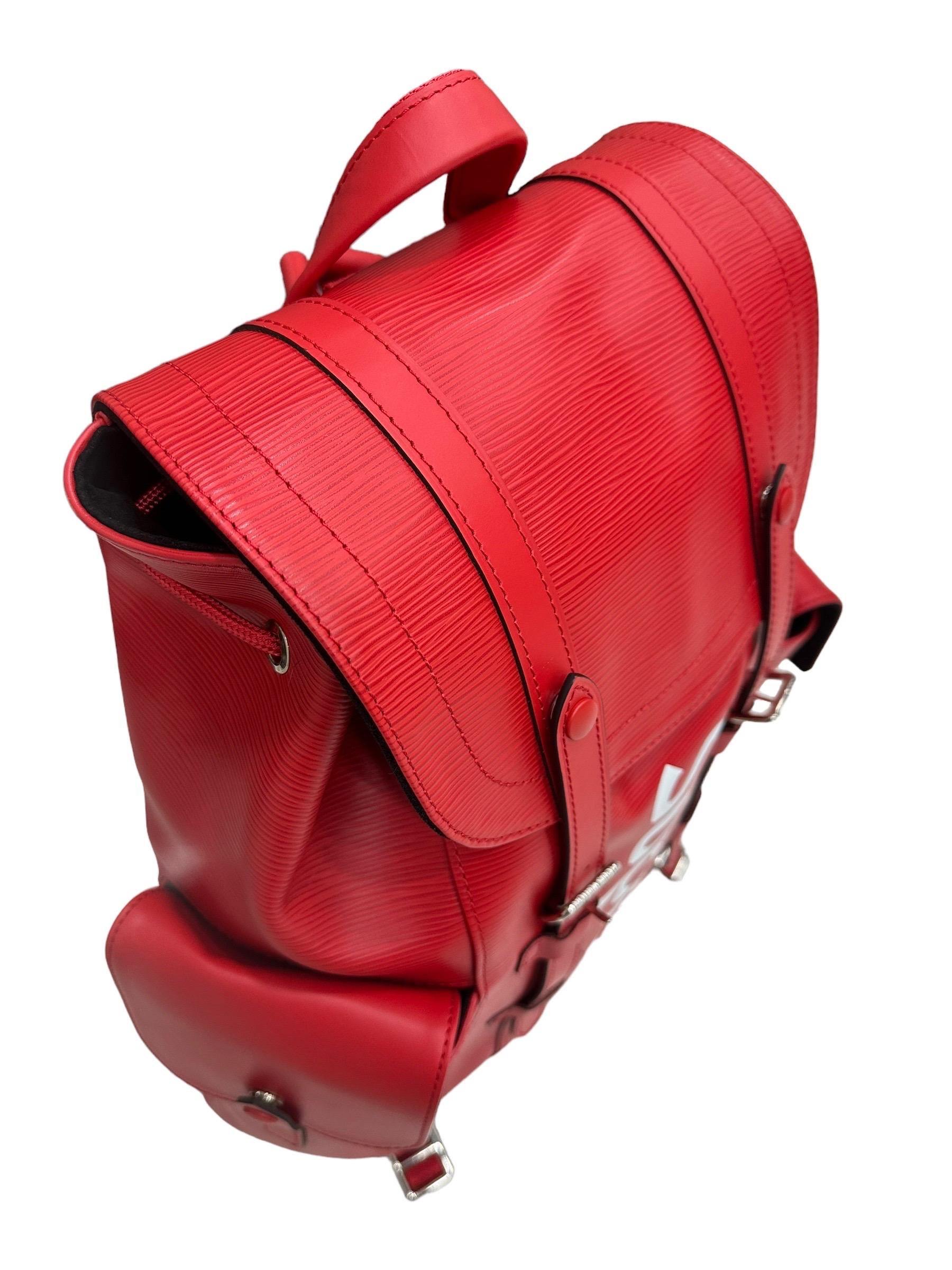 

Louis Vuitton backpack, Christoper model, in limited edition in collaboration with Supreme. Crafted in red epi leather with white front lettering and silver hardware. Featuring a front flap with snap button closure or adjustable buckles. Equipped