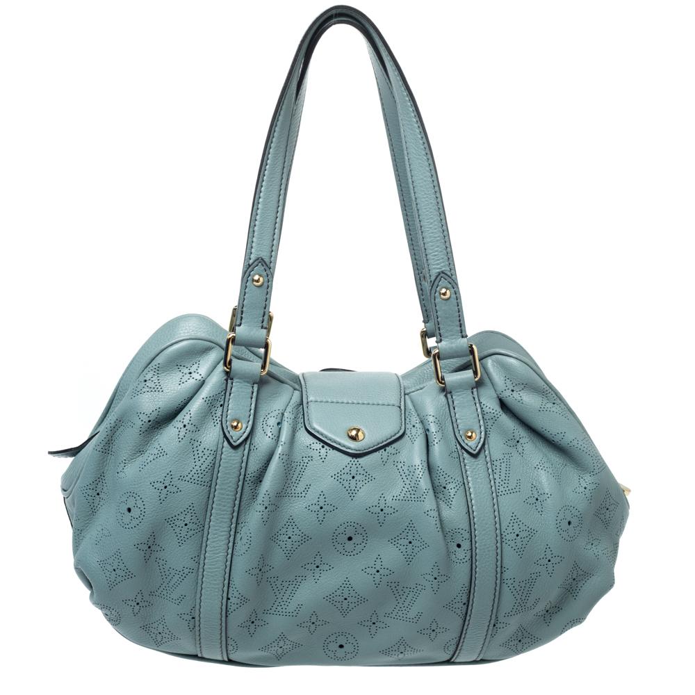 Louis Vuitton's Mahina collection was inspired by the crescents of the moon and this Lunar bag is a delight to own. Featuring a chic silhouette the bag comes with dual rolled top handles and protective metal feet. The push lock closure secures a