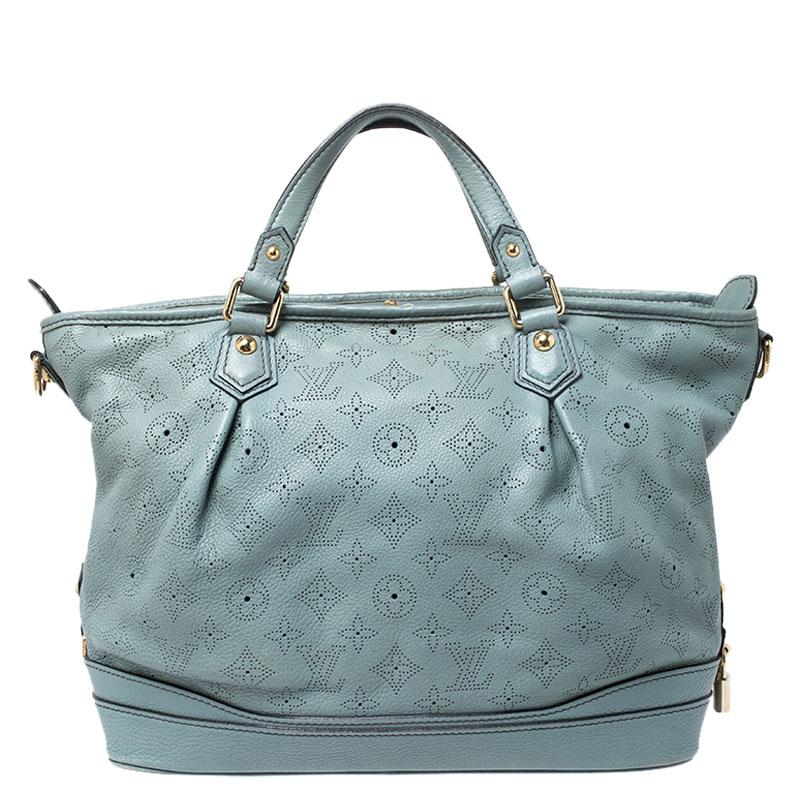 This bag from the house of Louis Vuitton is a delight to own. Louis Vuitton's Mahina collection was inspired by the crescents of the moon. Featuring a slightly slouchy silhouette, the bag comes with dual top handles, gold-tone hardware and