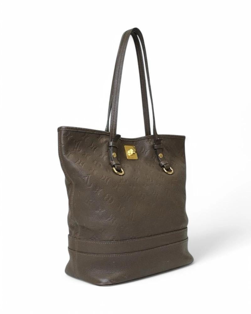 Louis Vuitton signature bag, model Citadine in size GM, made of brown Empreinte leather with gold hardware. Featuring an interlocking top closure, internally lined in tone-on-tone fabric with convenient pocket, the bag is quite roomy. Equipped with