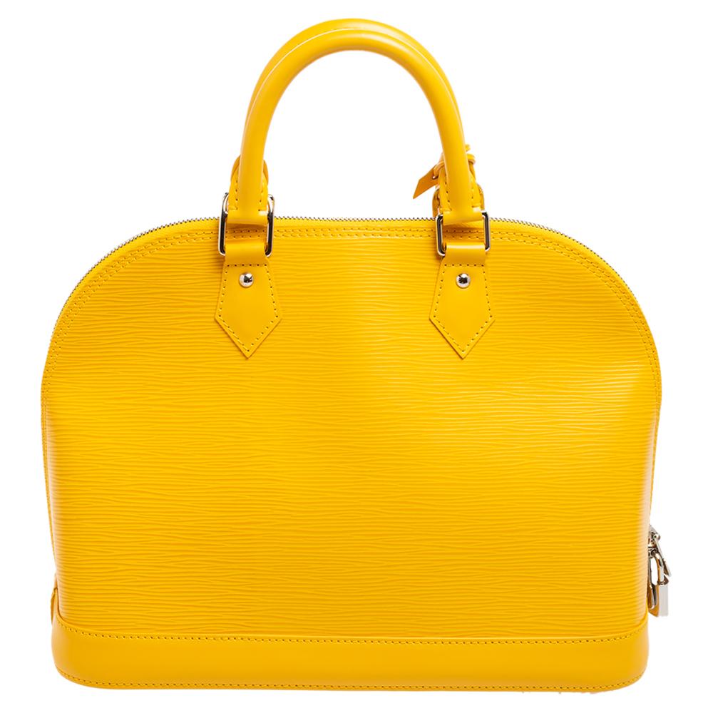 An icon of House Louis Vuitton, the Alma bag is easily one of the most popular bags that people invest in. Get yours today with this citron-hued Alma made of Epi leather. The bag is designed with double zippers and an Alcantara interior. Two rolled