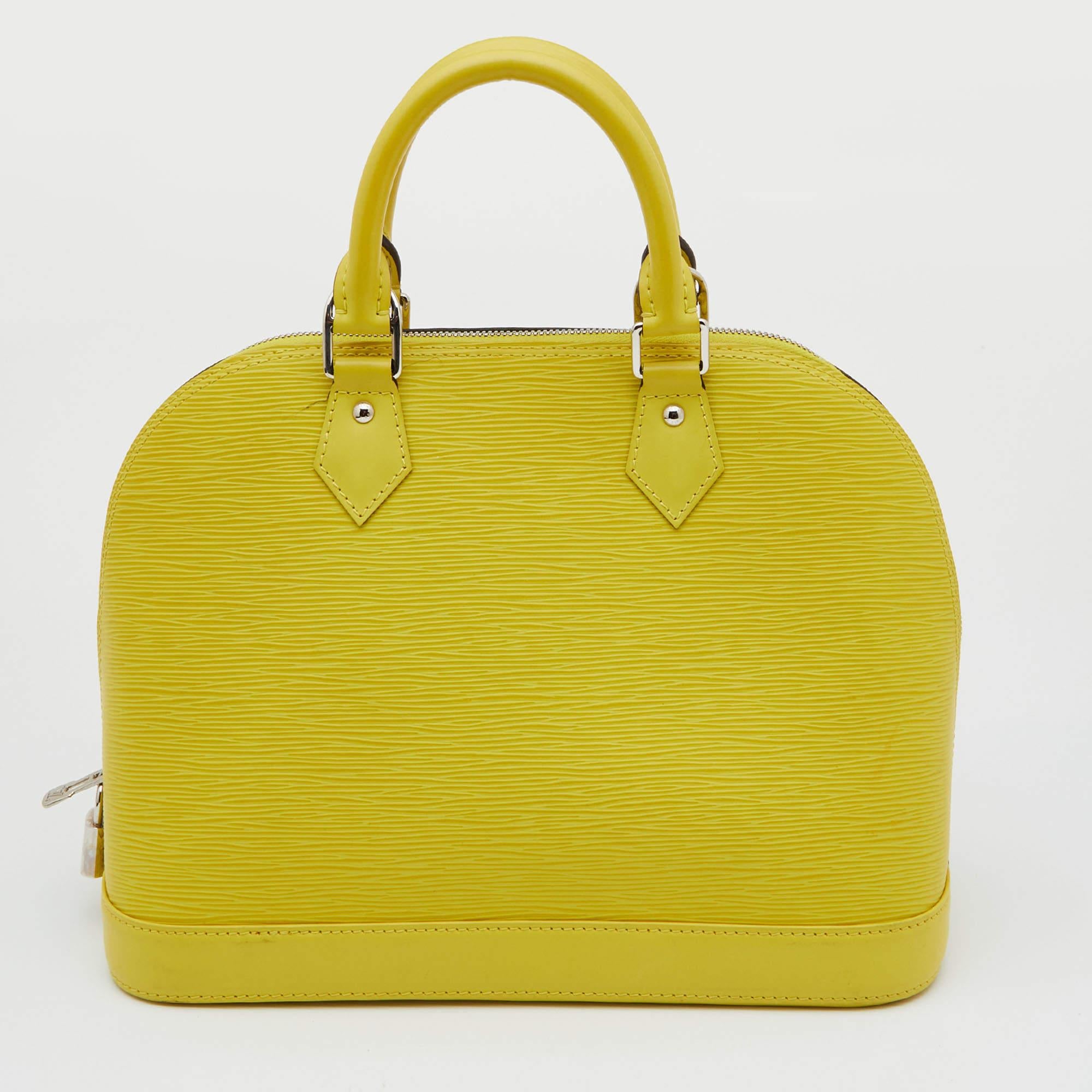 A classic from the house of Louis Vuitton, the shape of the Alma stands out. Louis Vuitton Alma was named after the Alma Bridge that connects Paris' fashionable neighborhood. Made from the signature Epi leather, the bag features dual top handles and