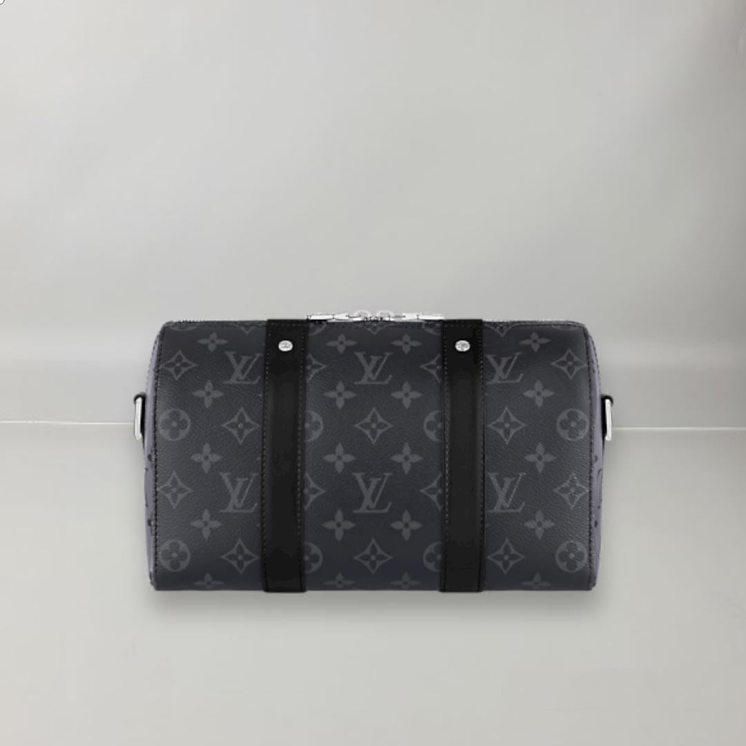 This classic Louis Vuitton Keepall bag is resized to become an elegant and functional city model in Monogram Eclipse canvas. Echoing the Upside Down collection created by Kim Jones in 2018, the famous Monogram print appears upside down on the sides