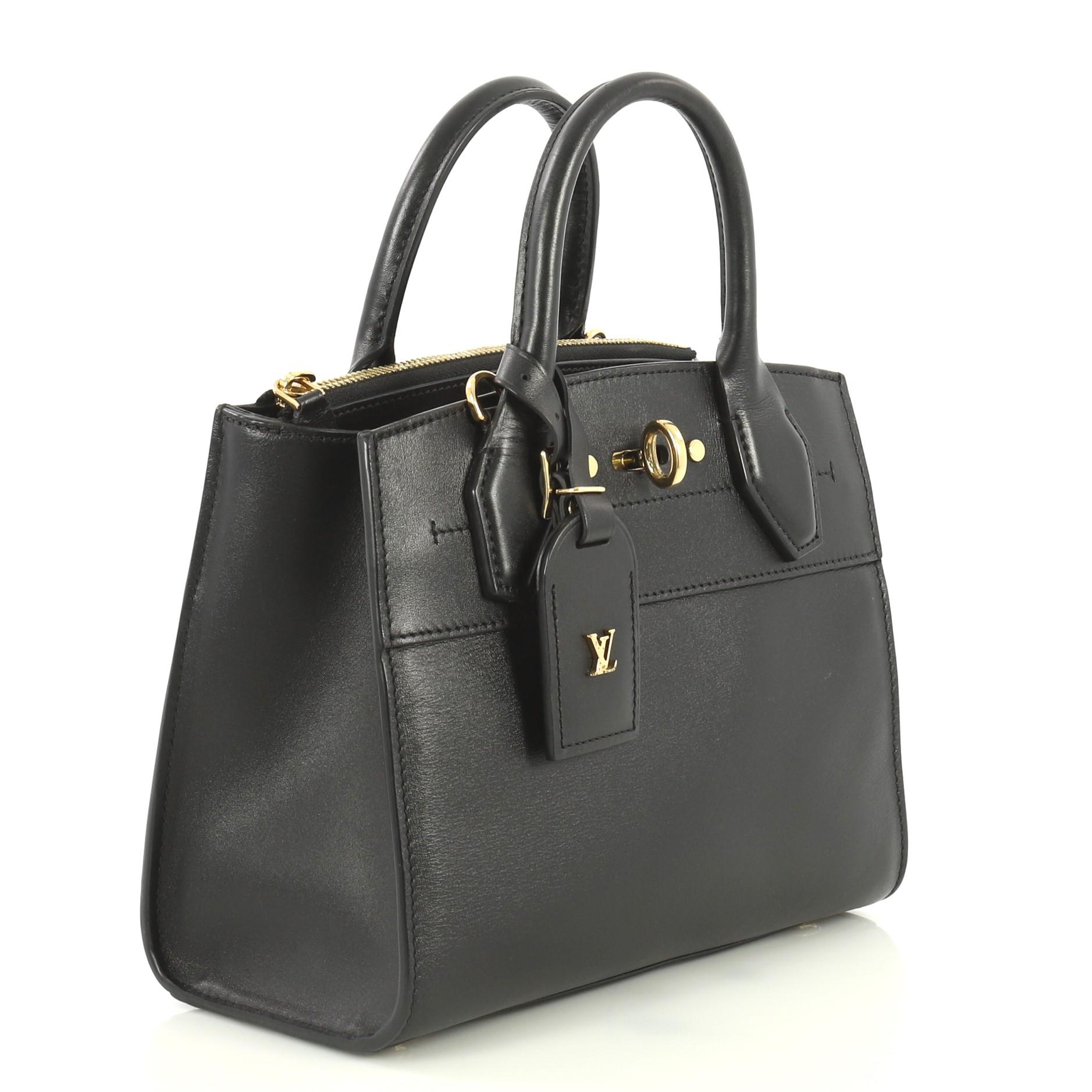 This Louis Vuitton City Steamer Handbag Leather Mini, crafted in black leather, features dual rolled leather handles, front central lock with LV stamped logo, and gold-tone hardware. It opens to a black leather interior with rear zip compartment and