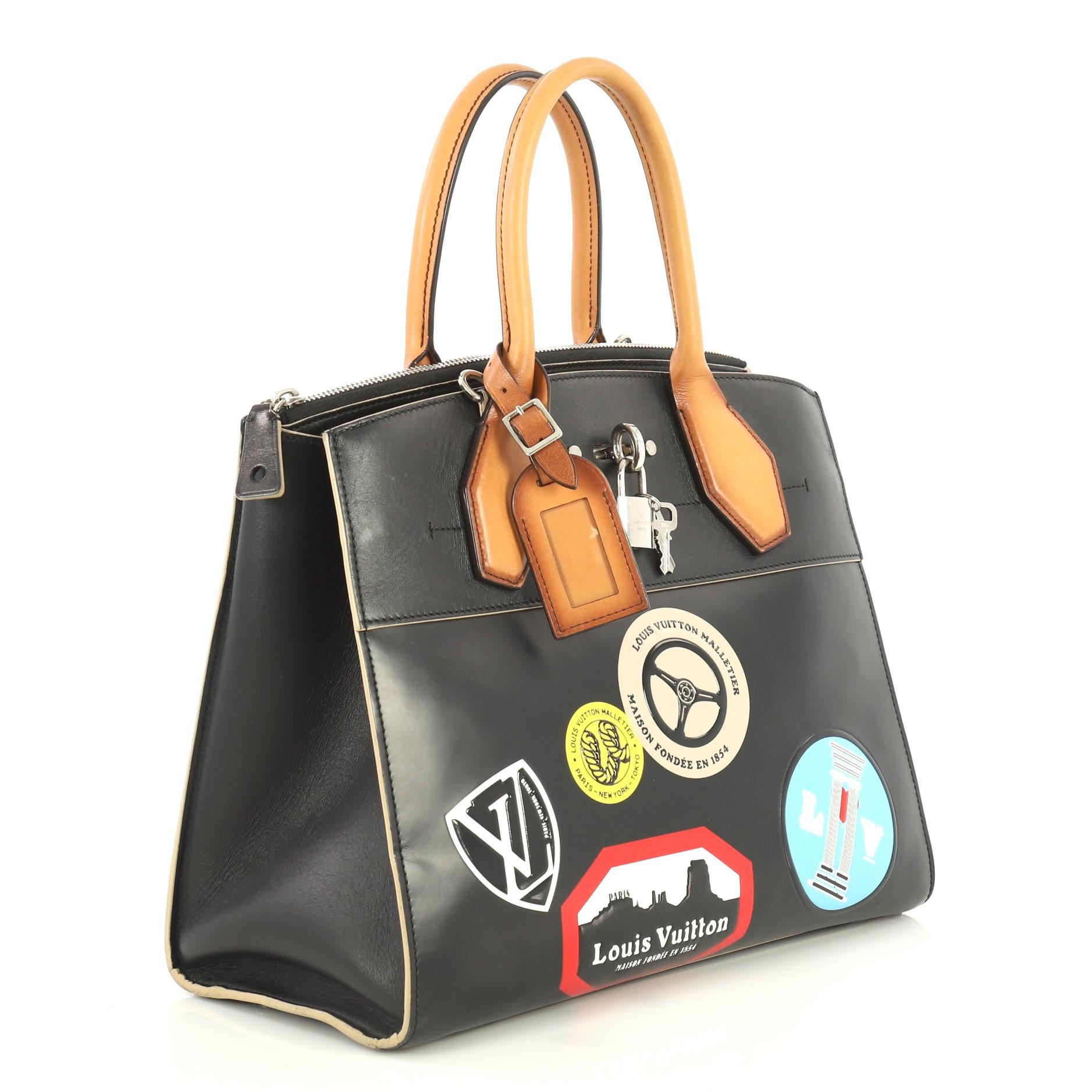 This Louis Vuitton City Steamer Handbag Limited Edition World Tour Leather MM, crafted from black leather, features dual rolled leather handles, front central lock with LV stamped logo, world tour stickers and silver-tone hardware. Its hook closure
