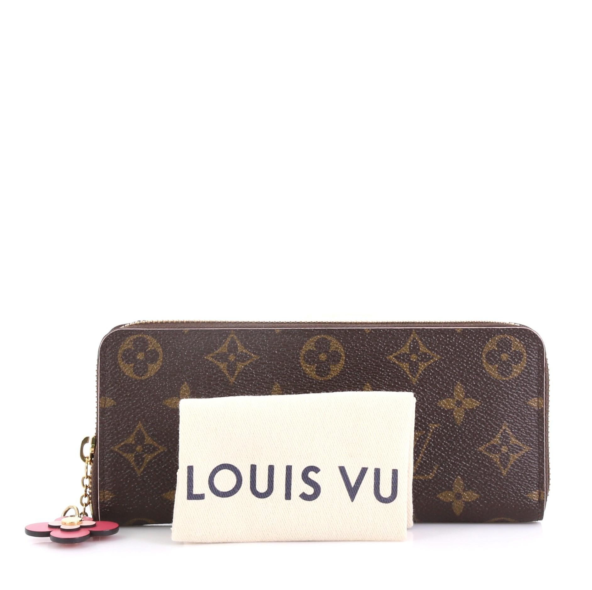 This Louis Vuitton Clemence Wallet Limited Edition Bloom Flower Monogram Canvas, crafted from brown monogram coated canvas, features gold-tone hardware. Its all-around zip closure opens to a pink leather interior with multiple card slots, two slip