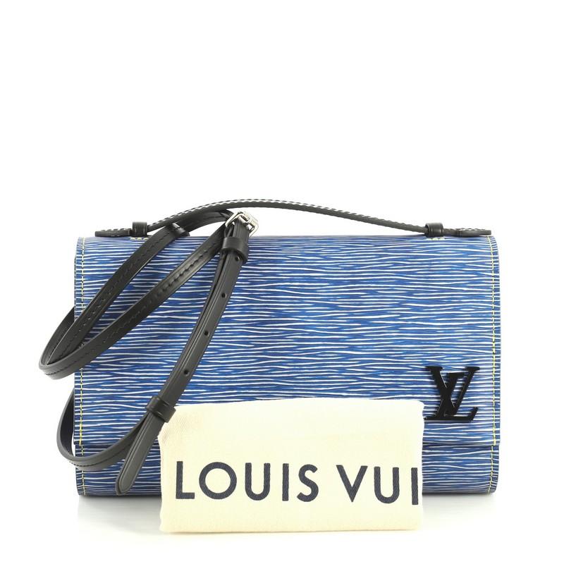 This Louis Vuitton Clery Handbag Epi Leather, crafted in blue epi leather, features leather top handle, adjustable leather strap, frontal flap with subtle LV logo and silver-tone hardware. Its hidden magnetic snap closure opens to a black fabric