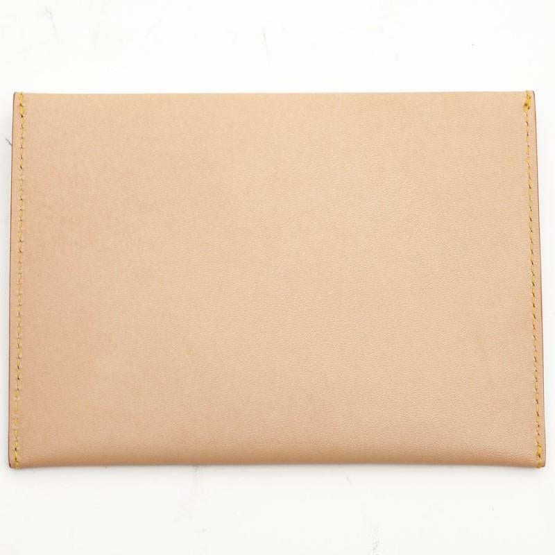 Closing with a gold snap, it is in nude leather lined with identical suede.
Never used, slip this pouch easily in your bag or jacket to keep your papers safe. 
Dimensions: length 18 cm x 13 cm x 1
Delivered in a non original pouch.