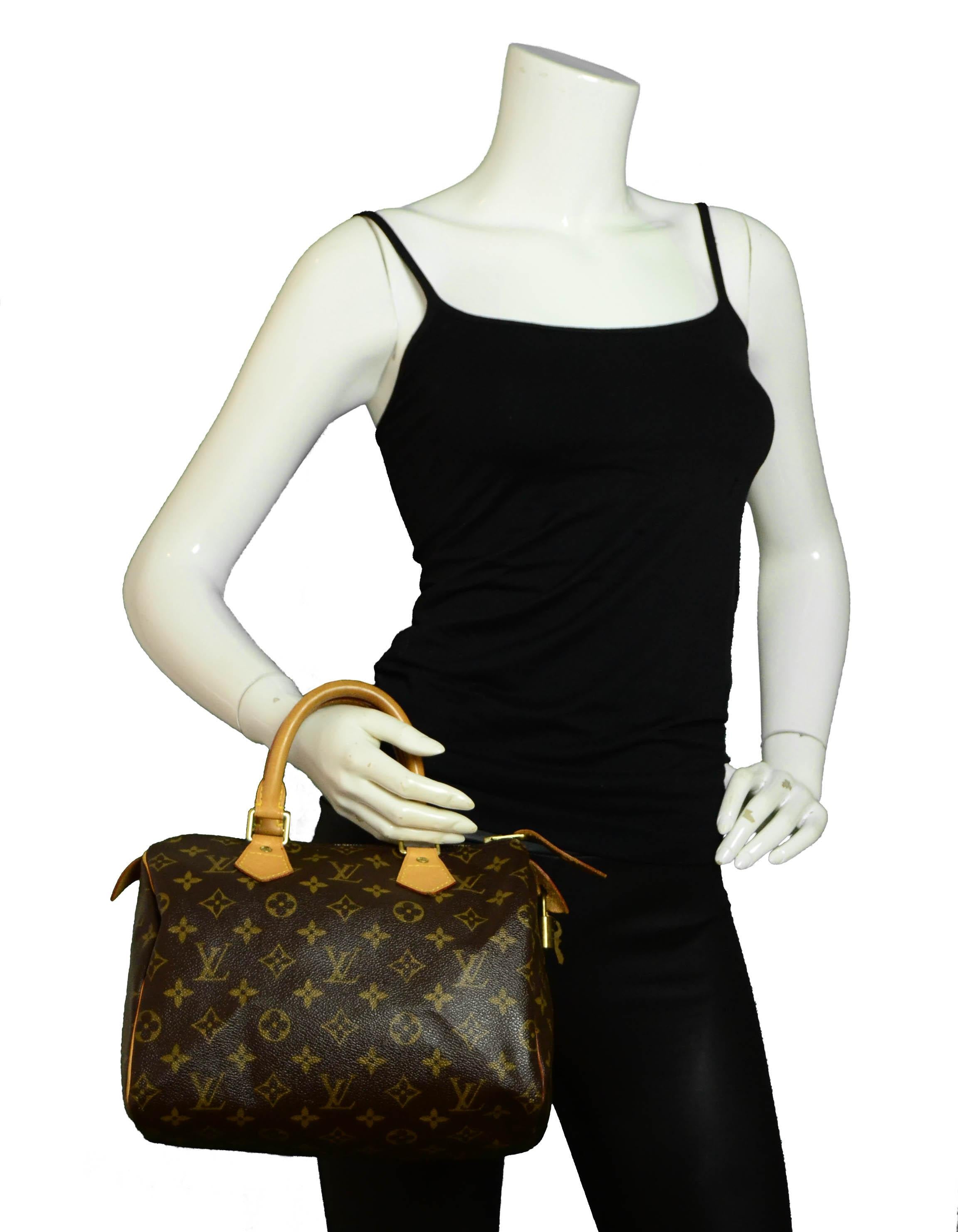 Louis Vuitton Coated Canvas Monogram Speedy 25 Bag

Made In: U.S.A.
Year of Production: 2005
Color: Brown
Hardware: Goldtone hardware
Materials: Coated canvas, vachetta leather trim
Lining: Brown textile lining
Closure/Opening: Top zip
Exterior