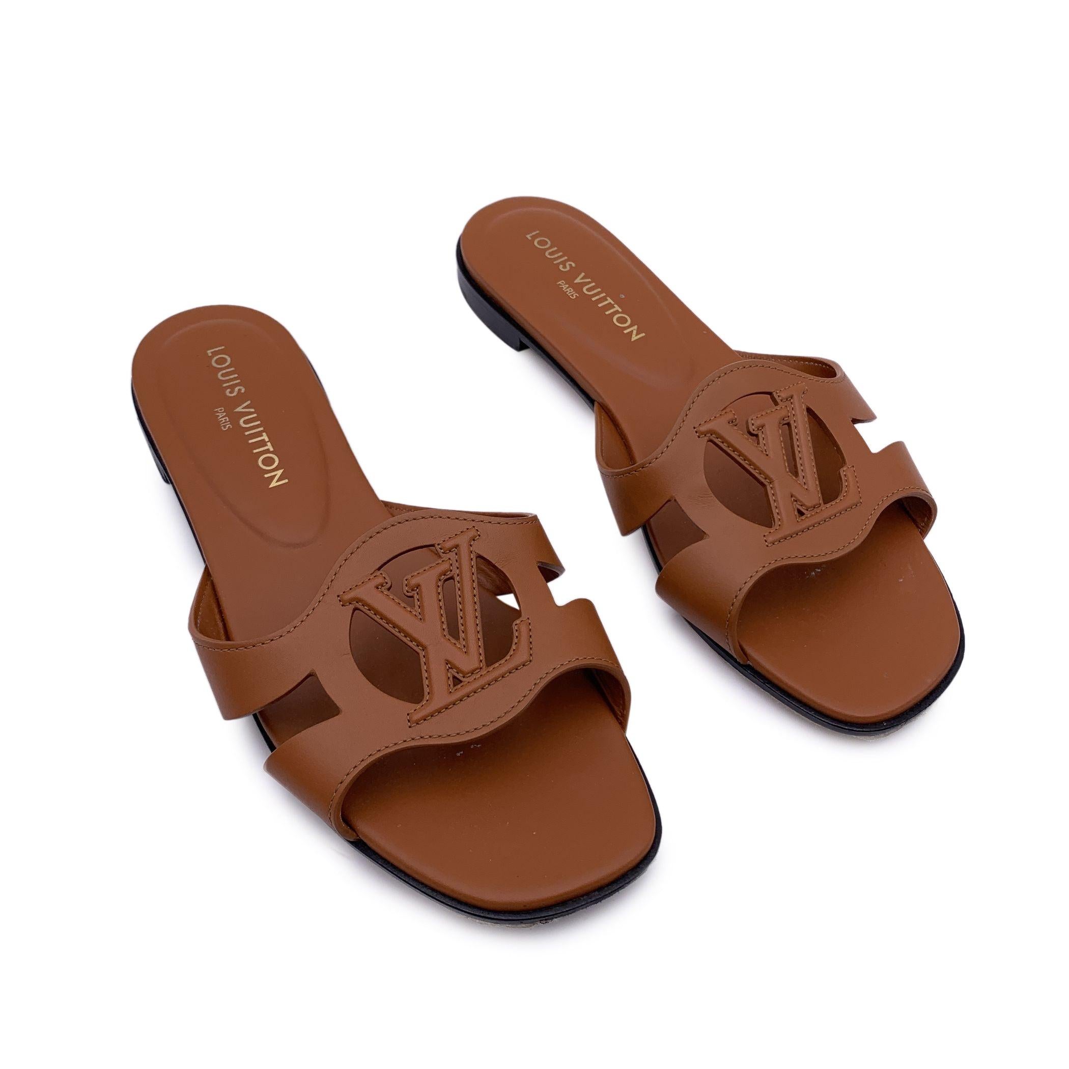 Louis Vuitton 'Isola' flat sandals in brown Cognac calfskin leather. LV Circle cut-out logo in an oversized version on the wide front strap. Anatomical footbed, for maximum comfort. Leather ousoles. Made in Italy. Size 41 (it should correspond to a