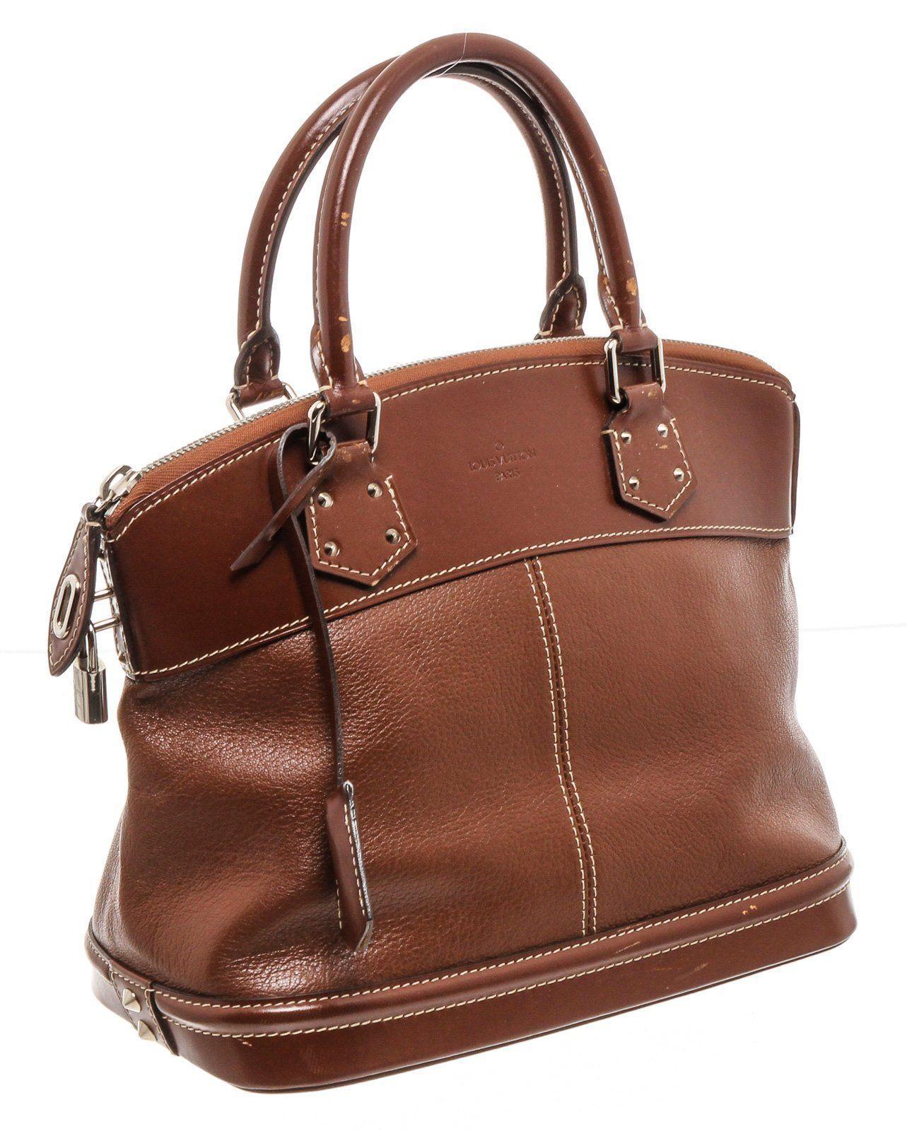Cognac Suhali leather Louis Vuitton Lockit PM with silver-tone hardware, tonal smooth leather trim, dual rolled top handles, contrast stitching throughout, tonal monogrammed woven lining, single interior zip pocket at wall and zip closure at