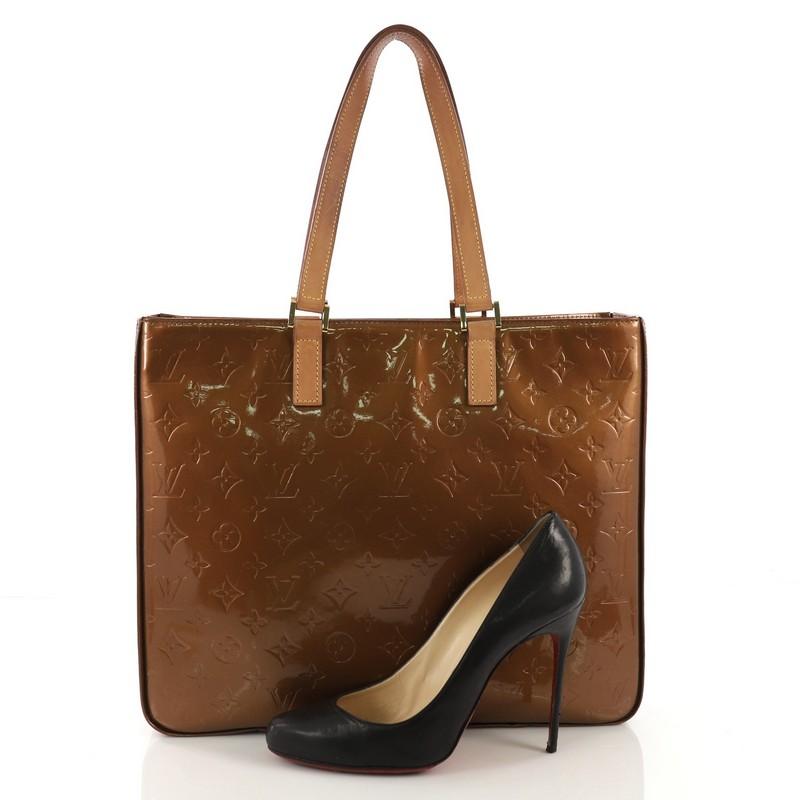 This Louis Vuitton Columbus Handbag Monogram Vernis, crafted in brown monogram vernis leather, features dual flat leather handles and gold-tone hardware. Its zip closure opens to a brown leather interior with slip pockets. Authenticity code reads:
