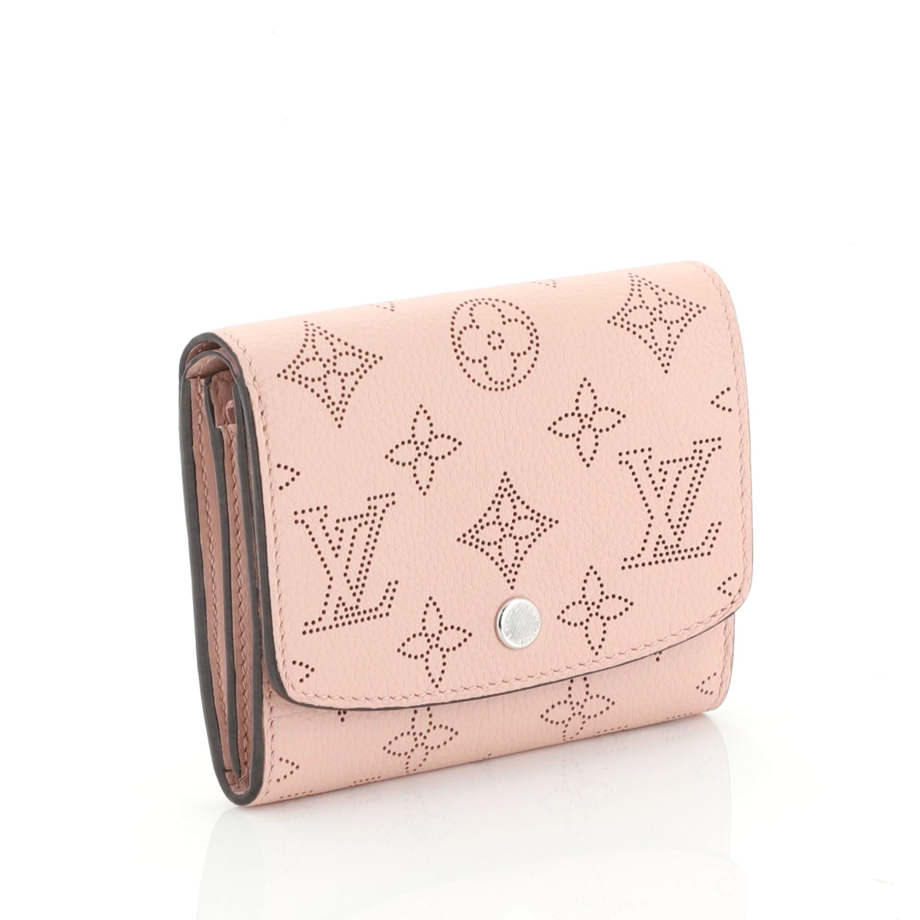 This Louis Vuitton Compact Iris Wallet NM Mahina Leather, crafted from pink mahina leather, features silver-tone hardware. Its snap button closure opens to a pink leather interior with zip and slip pockets. Authenticity code reads: TN2149.