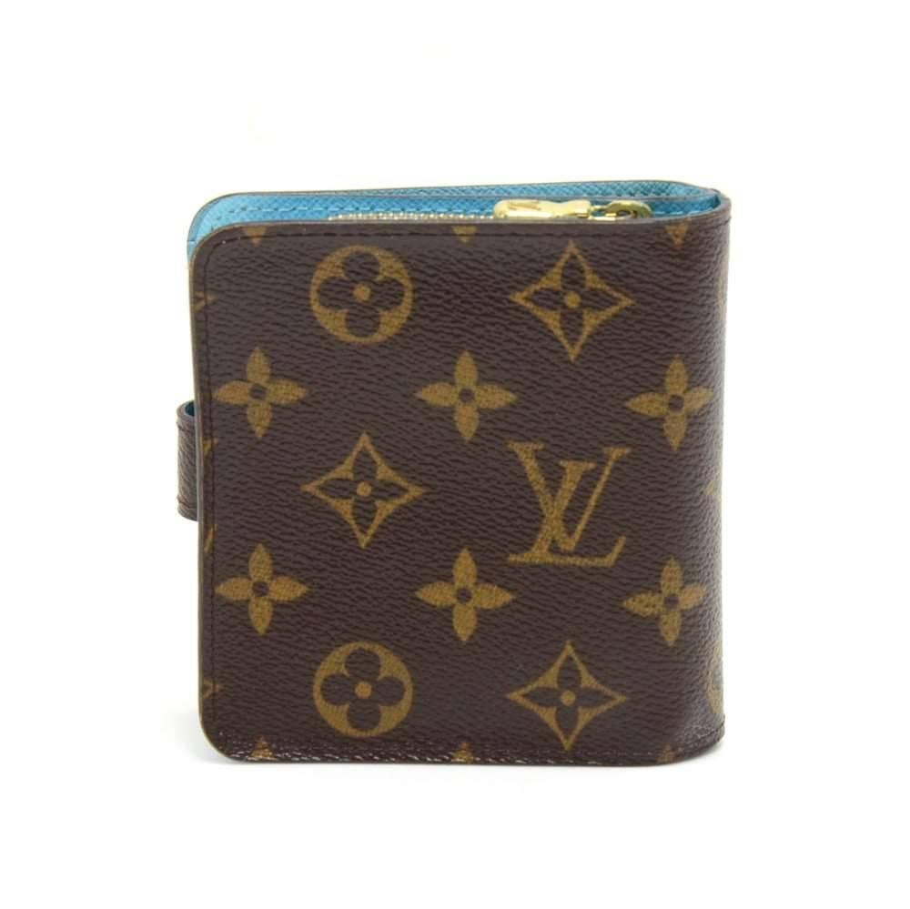 Authentic Louis Vuitton Compact Zip Groom monogram canvas wallet.  Has a stud button closure.  The main compartment has 5 slots for cards and compartment for notes/receipts. It also has a 2-compartment coin case with a zipper closure. This model is