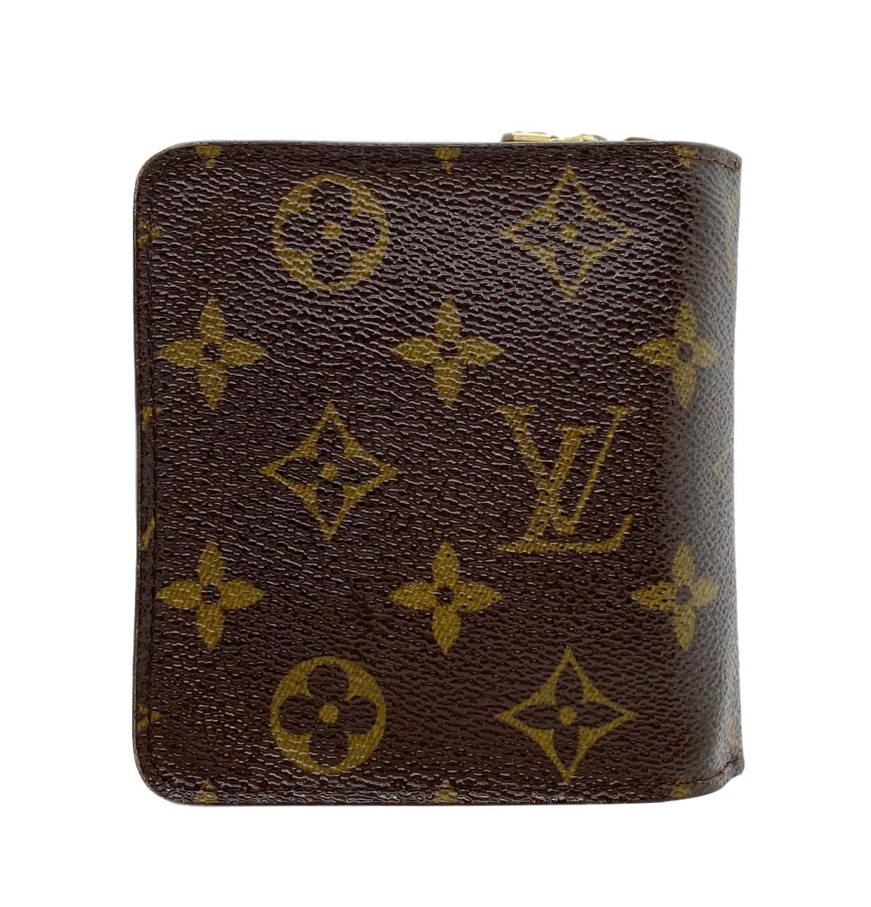 Vintage Louis Vuitton compact zip PM French Purse wallet in brown and tan monogram coated
canvas. Dated, CA0075, Spain – July 2005. Wallet has brass hardware, snap closure at front
opening to brown Taiga leather lined interior. Interior has a single