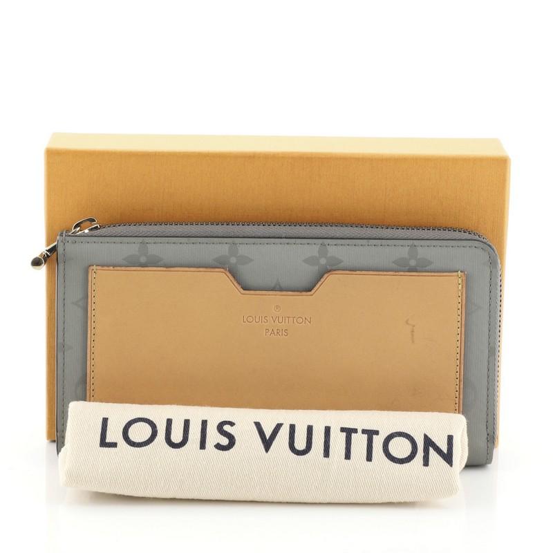 This Louis Vuitton Cosmos Wallet Limited Edition Titanium Monogram Canvas Long, crafted in green canvas, features an exterior slip pocket and silver-tone hardware. Its zip closure opens to a green leather interior. Authenticity code reads: TS2148