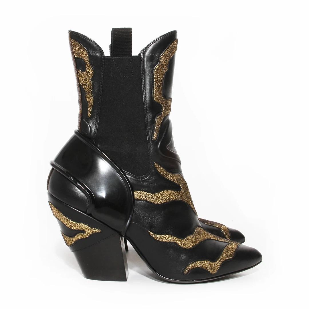 Vintage Louis Vuitton by Nicolas Ghesquière Boots 
Resort 2018 
Made in Italy 
Cowboy style boot
Black leather 
Gold flame details 
Block heel 
Black patent leather detail on back 
Stretch fabric on sides of boot 
Louis Vuitton canvas logo detail on