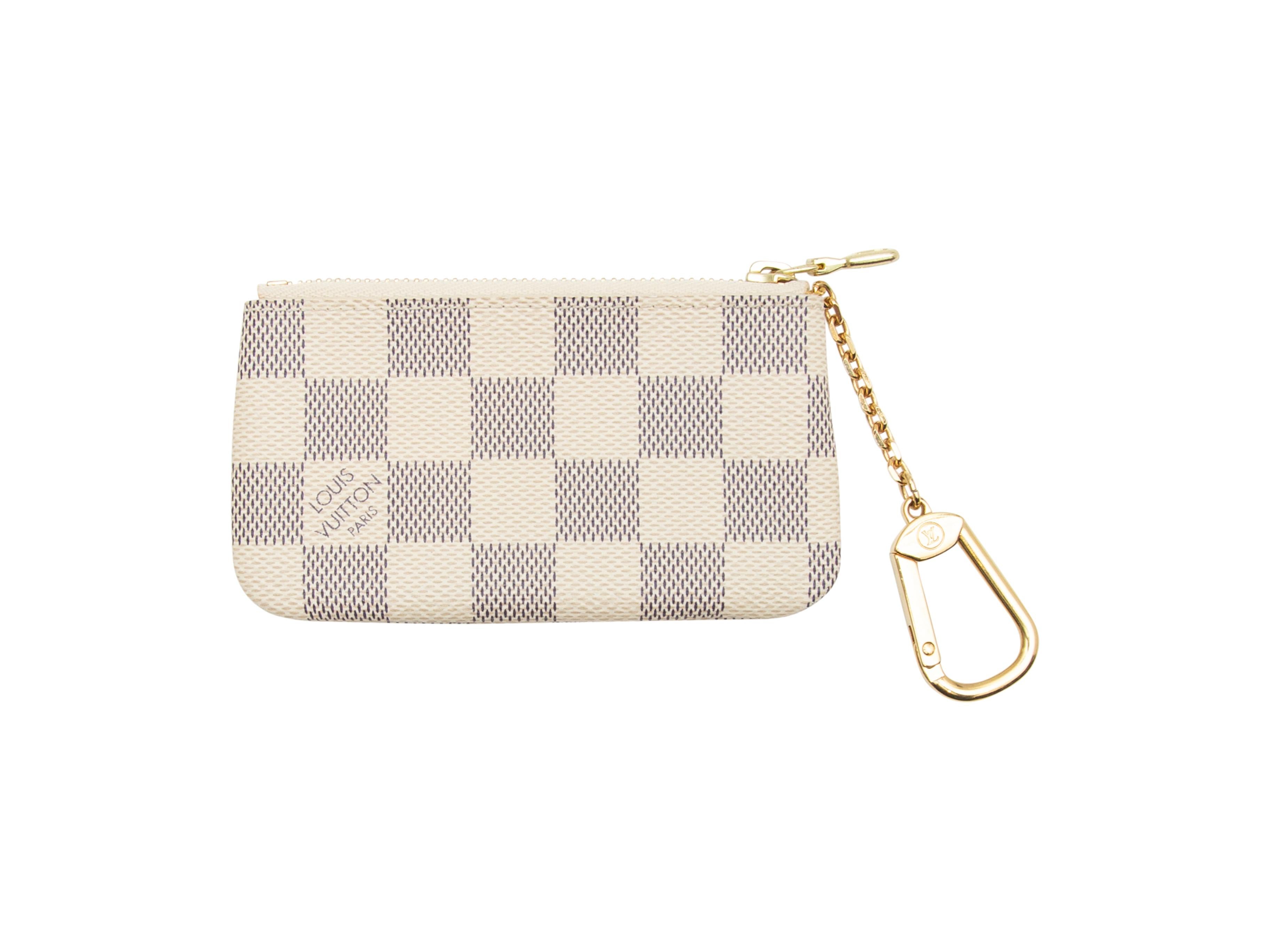 Product details: Cream and black Damier Azur key pouch by Louis Vuitton. Gold-tone hardware. Zip closure at top. 2.5